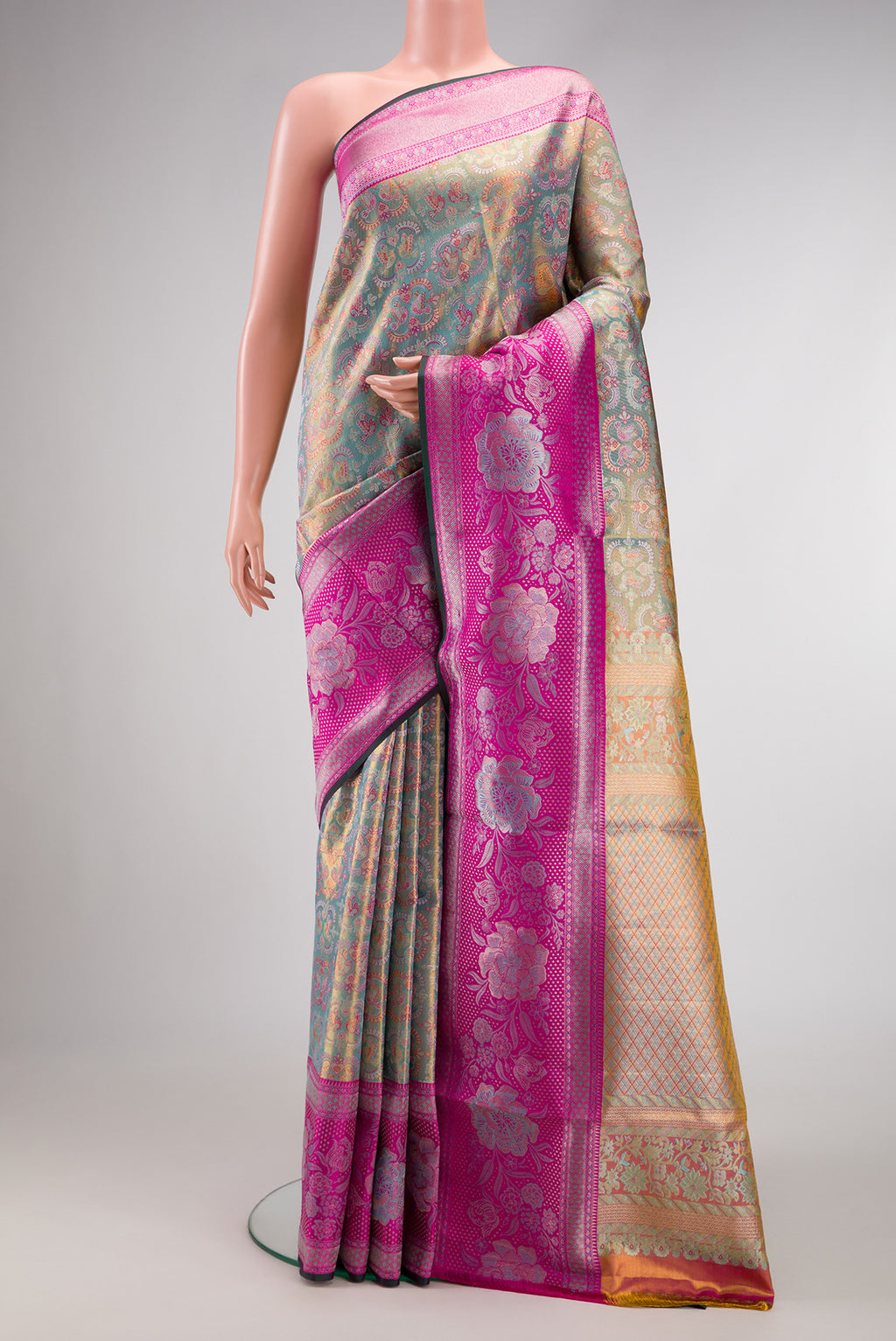 Sea Green Dual Tone Kanjivaram Tissue Silk Saree with Zari Brocade on the body and Fancy Border.  displayed on a mannequin