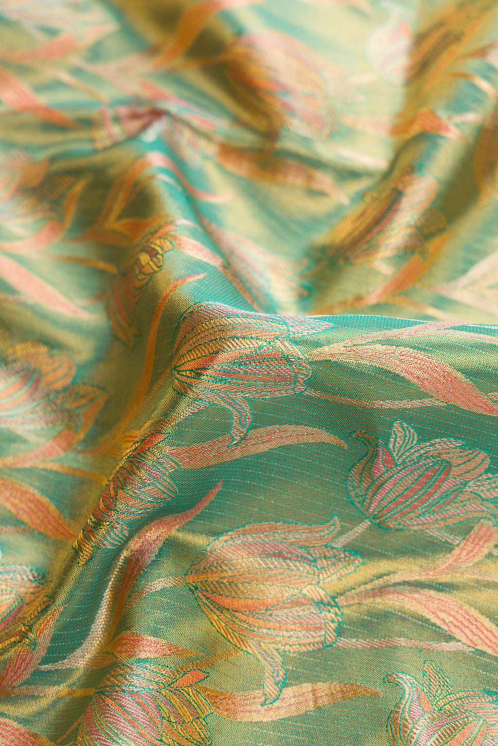 Close up of Green Dual Tone Kanjivaram Tissue Silk Saree with Zari Brocade on the body and Fancy Border.  displaying folds