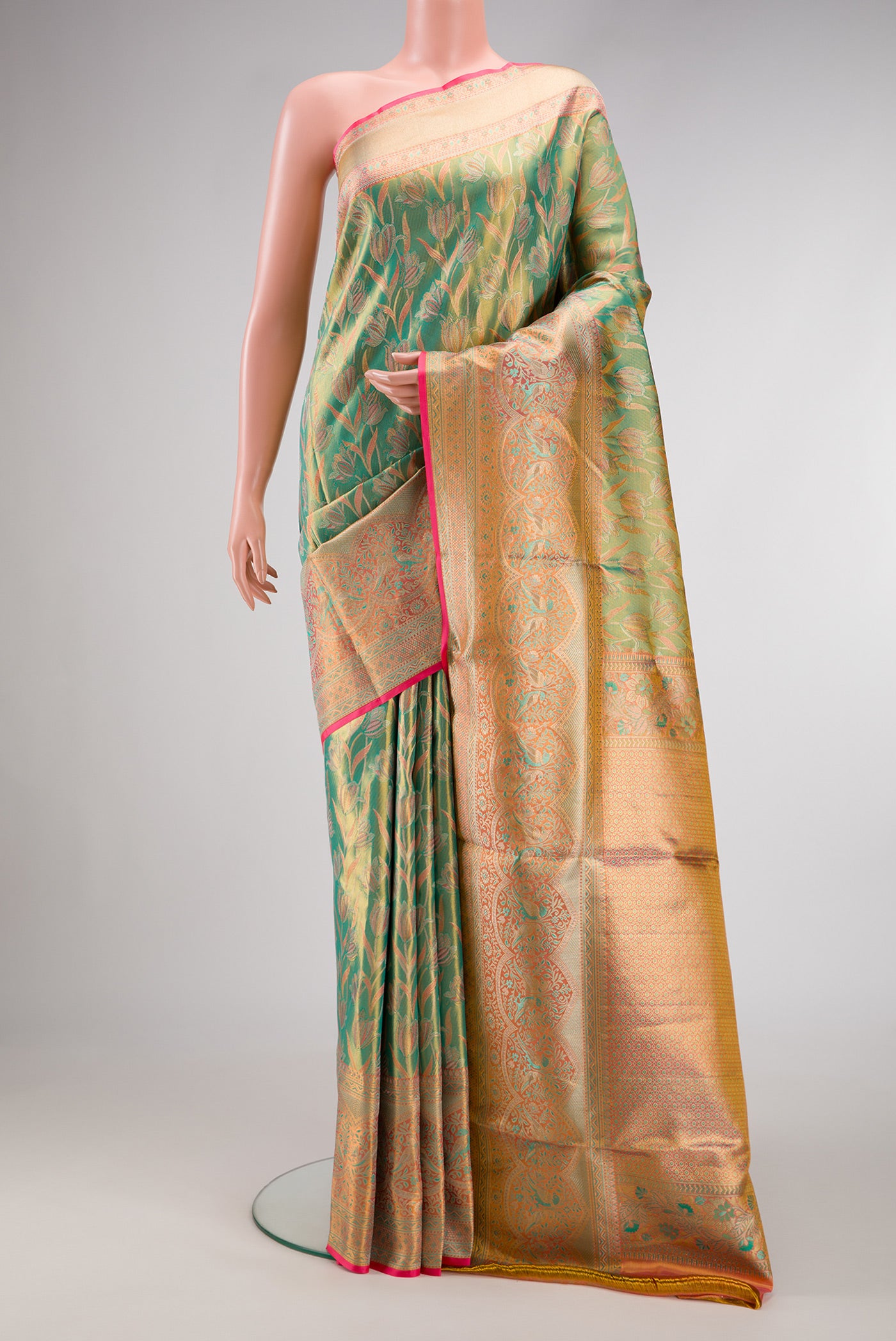 Green Dual Tone Kanjivaram Tissue Silk Saree with Zari Brocade on the body and Fancy Border.  displayed on a mannequin
