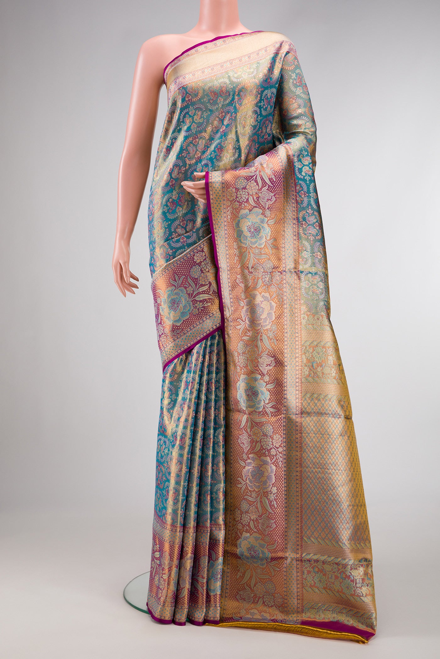 Light Blue Dual Tone Kanjivaram Tissue Silk Saree with Zari Brocade on the body and Fancy Border.  displayed on a mannequin