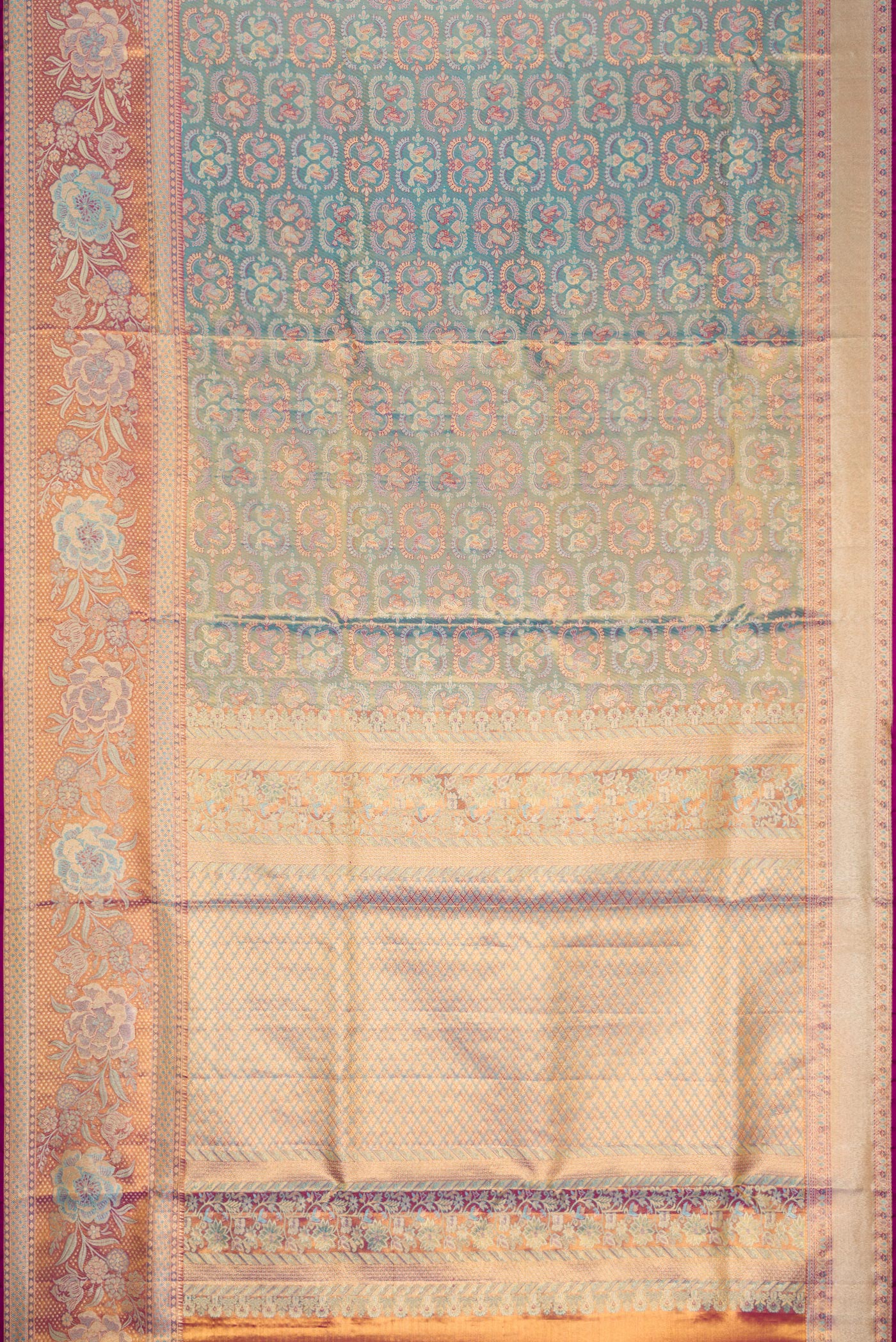 Flat view of Light Blue Dual Tone Kanjivaram Tissue Silk Saree with Zari Brocade on the body and Fancy Border. 