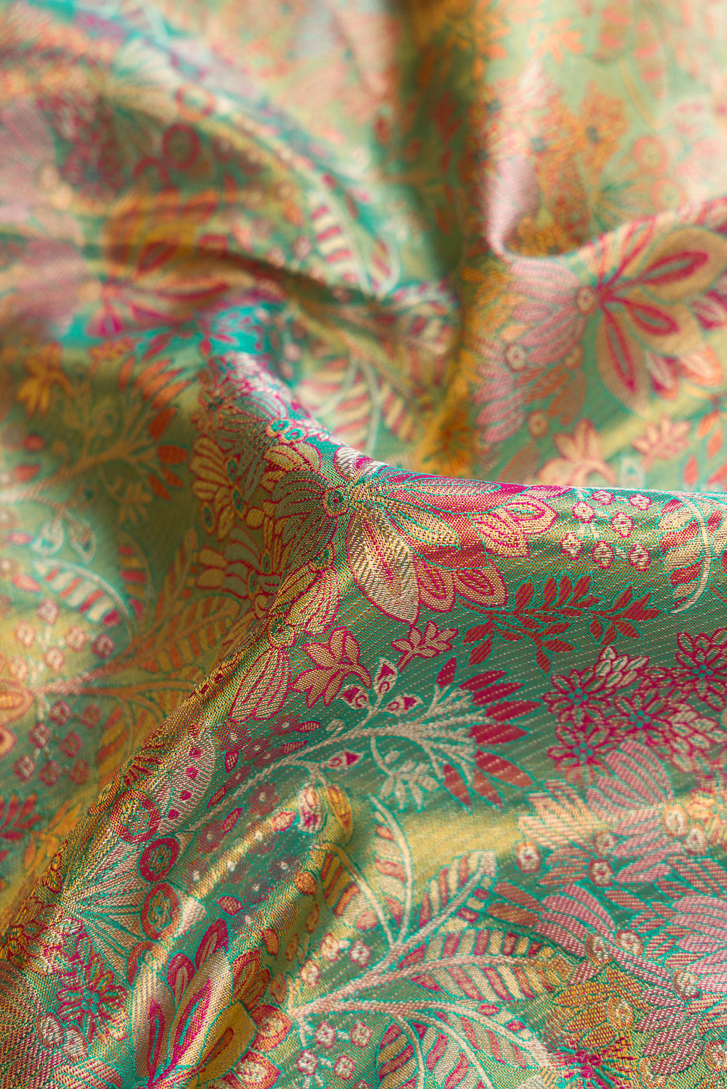 Close up of Sea Green Dual Tone Kanjivaram Tissue Silk Saree with Zari Brocade on the body and Fancy Border.  displaying folds