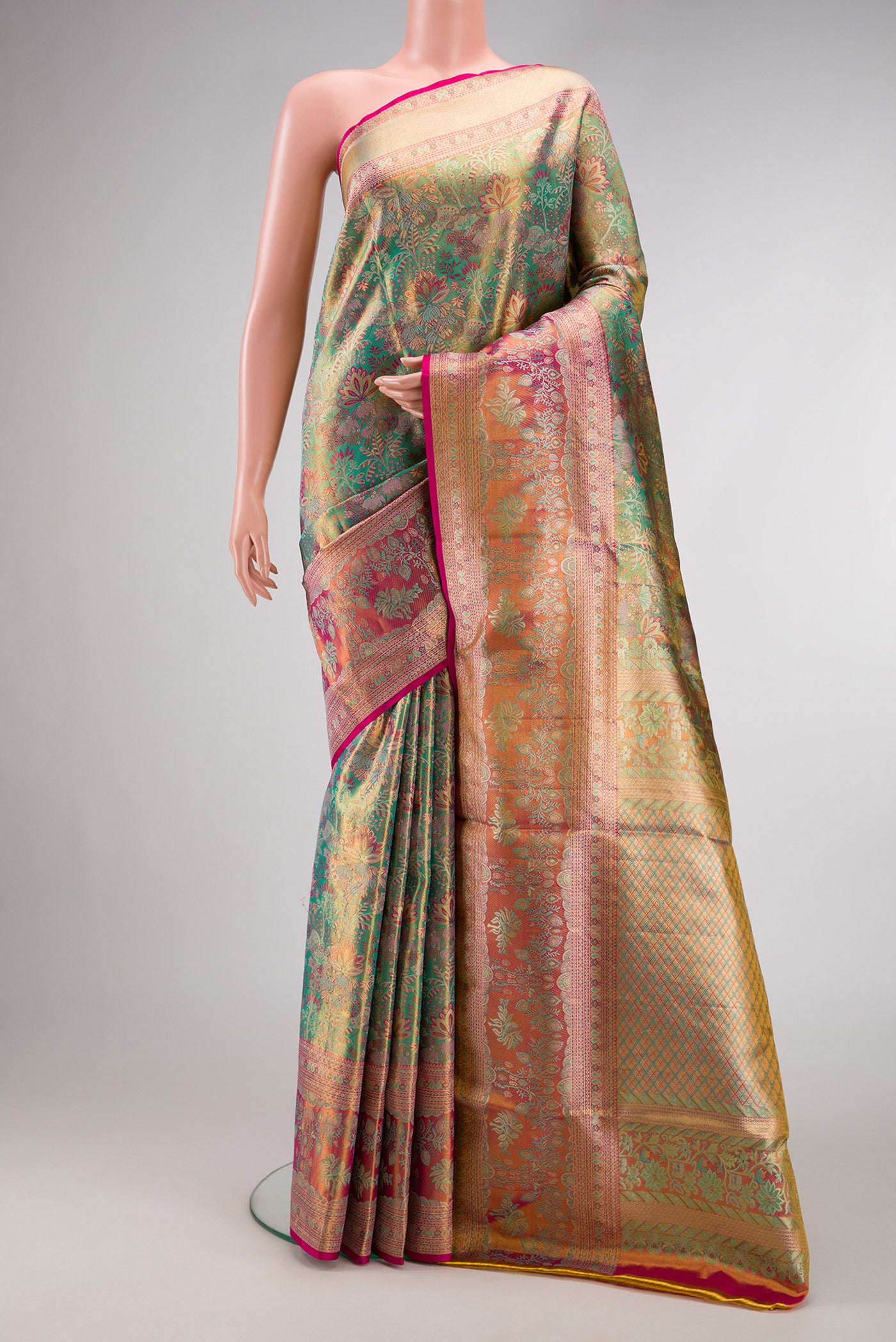 Sea Green Dual Tone Kanjivaram Tissue Silk Saree with Zari Brocade on the body and Fancy Border.  displayed on a mannequin