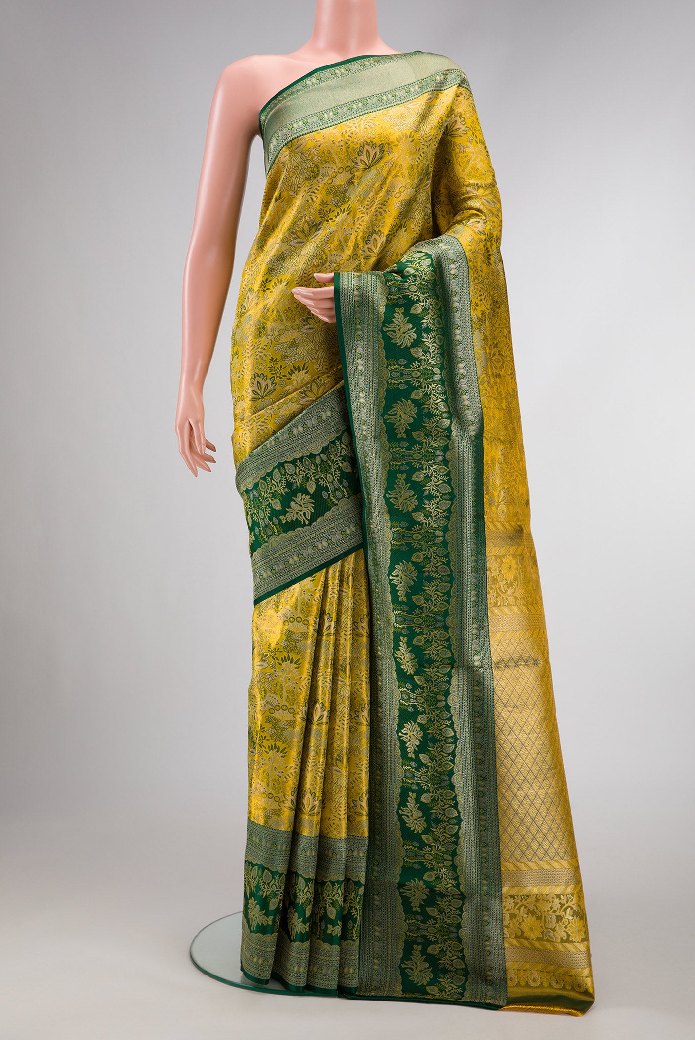 Green Dual Tone Kanjivaram Tissue Silk Saree with Zari Brocade on the body and Zari Border.  displayed on a mannequin