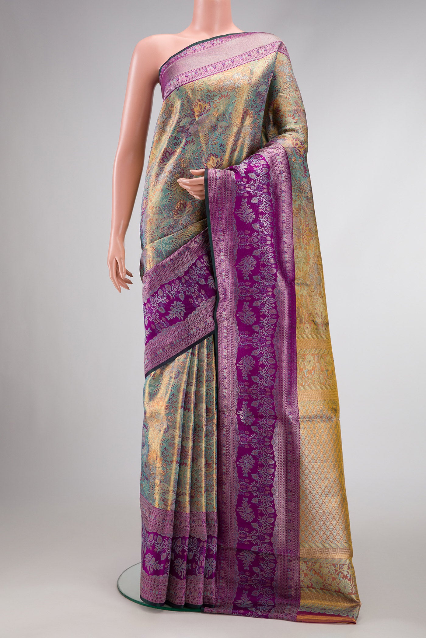 Gold Dual Tone Kanjivaram Tissue Silk Saree with Zari Brocade on the body and Zari Border.  displayed on a mannequin