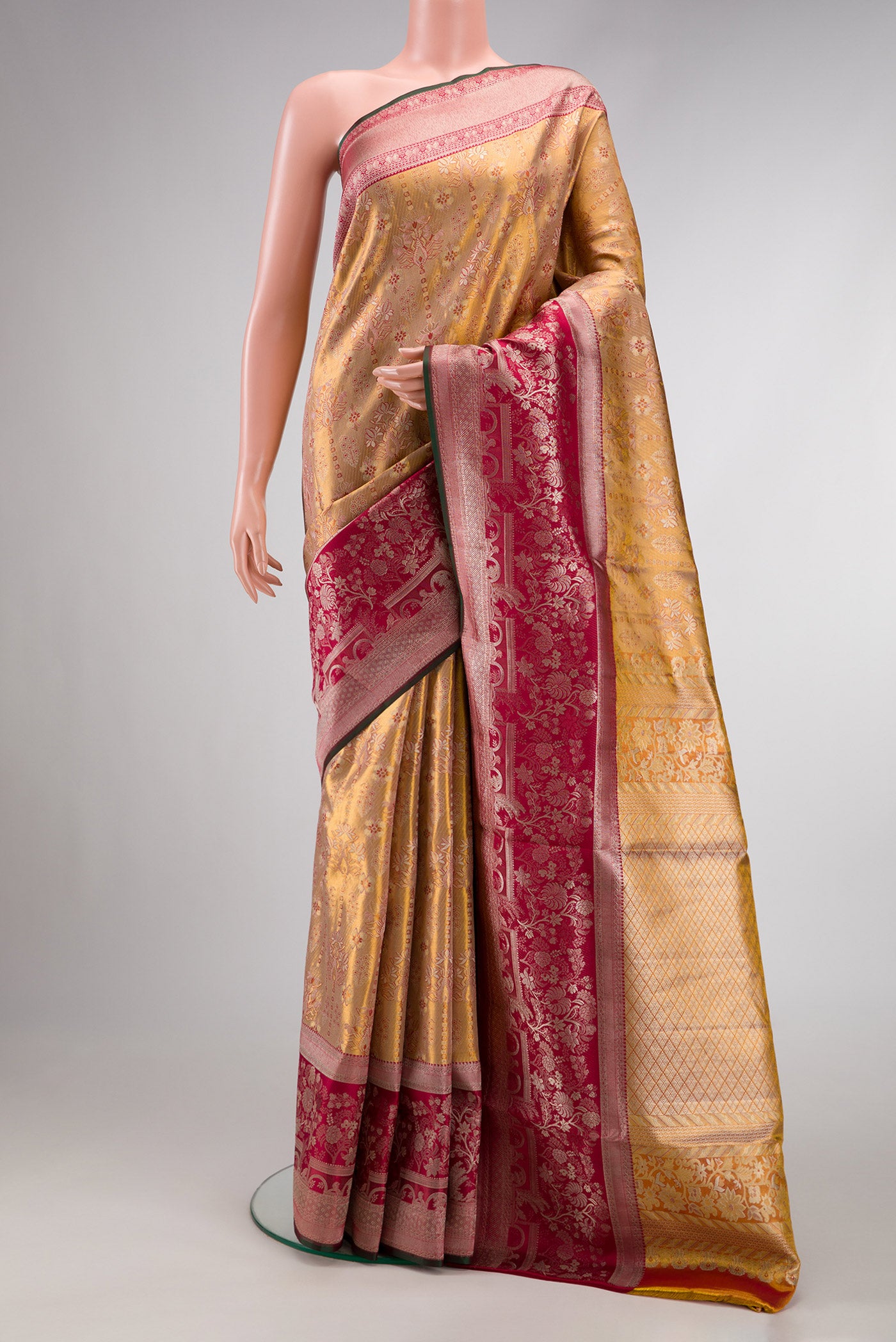 Gold Dual Tone Kanjivaram Tissue Silk Saree with Zari Brocade on the body and Zari Border.  displayed on a mannequin