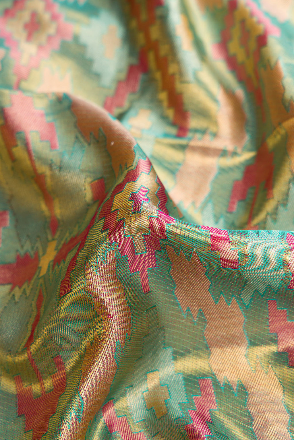 Close up of Sea Green Dual Tone Kanjivaram Tissue Silk Saree with Zari Brocade on the body and Fancy Border.  displaying folds