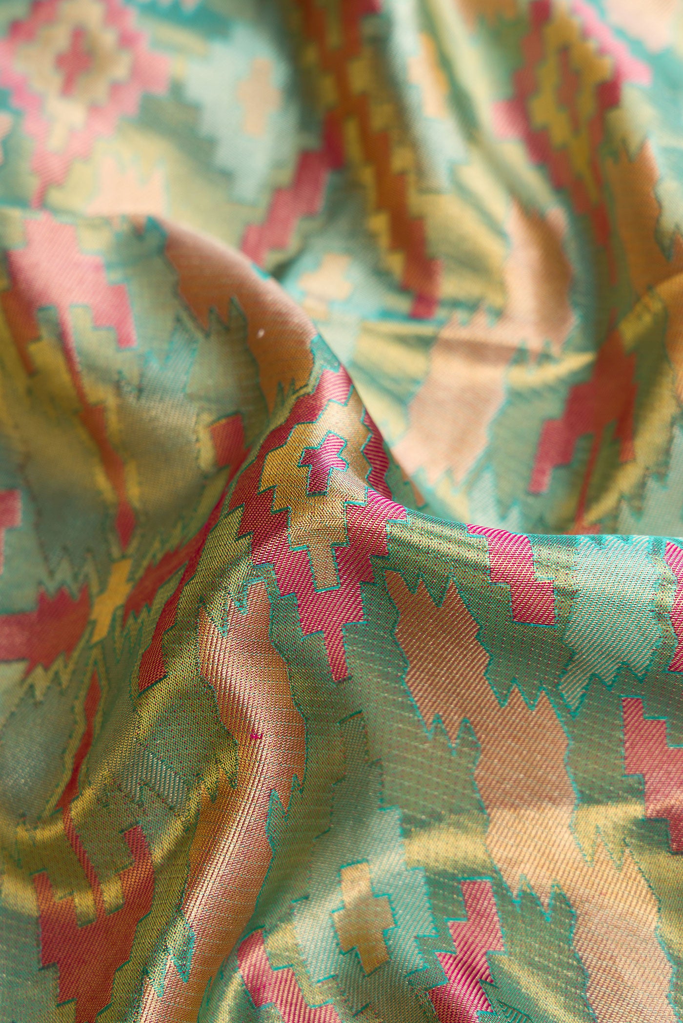 Close up of Sea Green Dual Tone Kanjivaram Tissue Silk Saree with Zari Brocade on the body and Fancy Border.  displaying folds