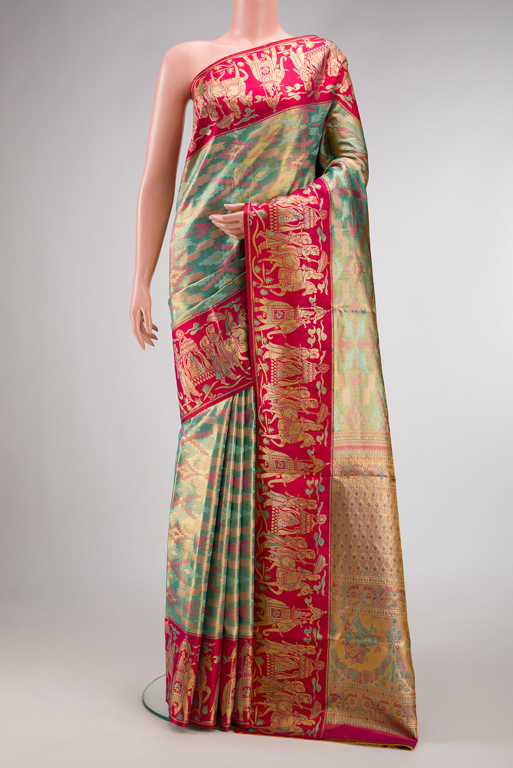Sea Green Dual Tone Kanjivaram Tissue Silk Saree with Zari Brocade on the body and Fancy Border.  displayed on a mannequin