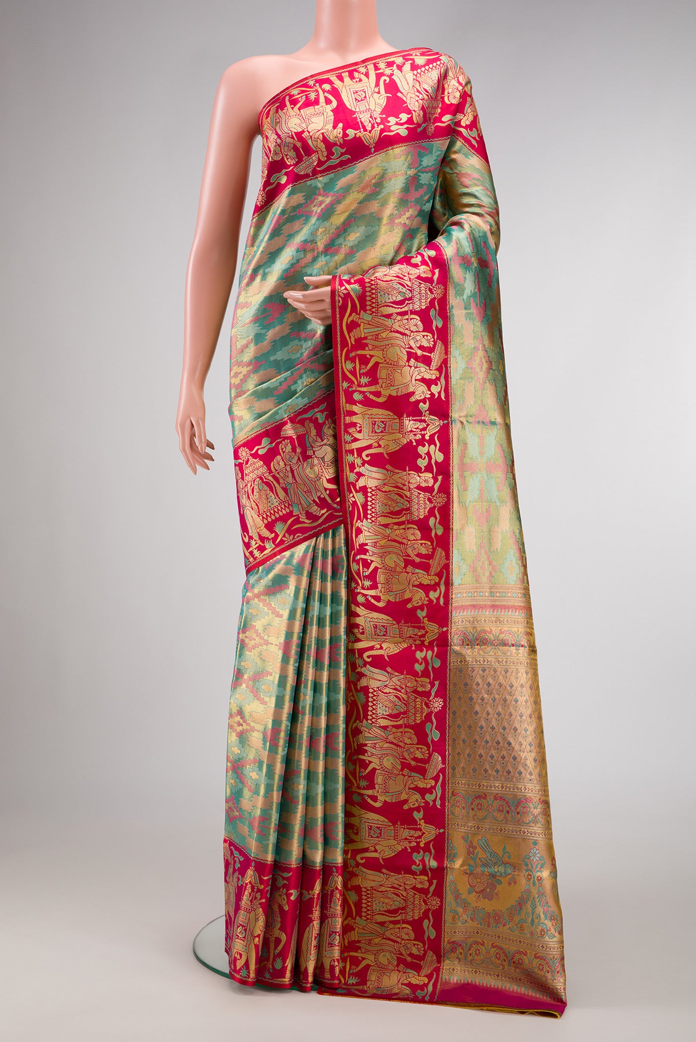 Sea Green Dual Tone Kanjivaram Tissue Silk Saree with Zari Brocade on the body and Fancy Border.  displayed on a mannequin