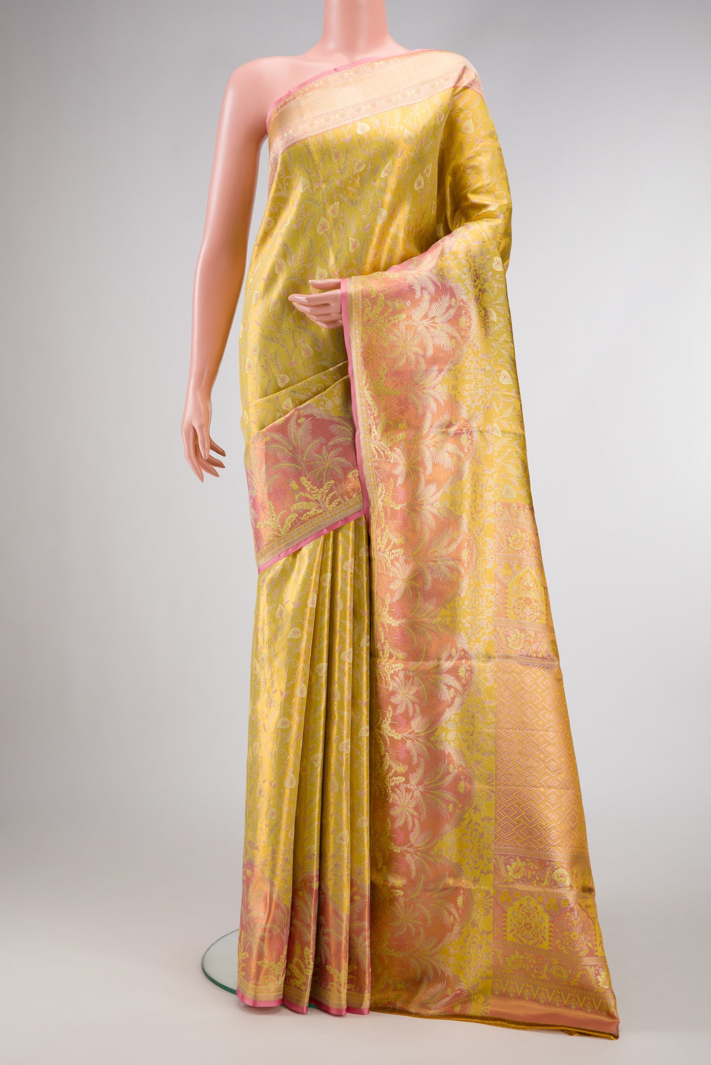 Yellow Dual Tone Kanjivaram Tissue Silk Saree with Zari Brocade on the body and Fancy Border.  displayed on a mannequin
