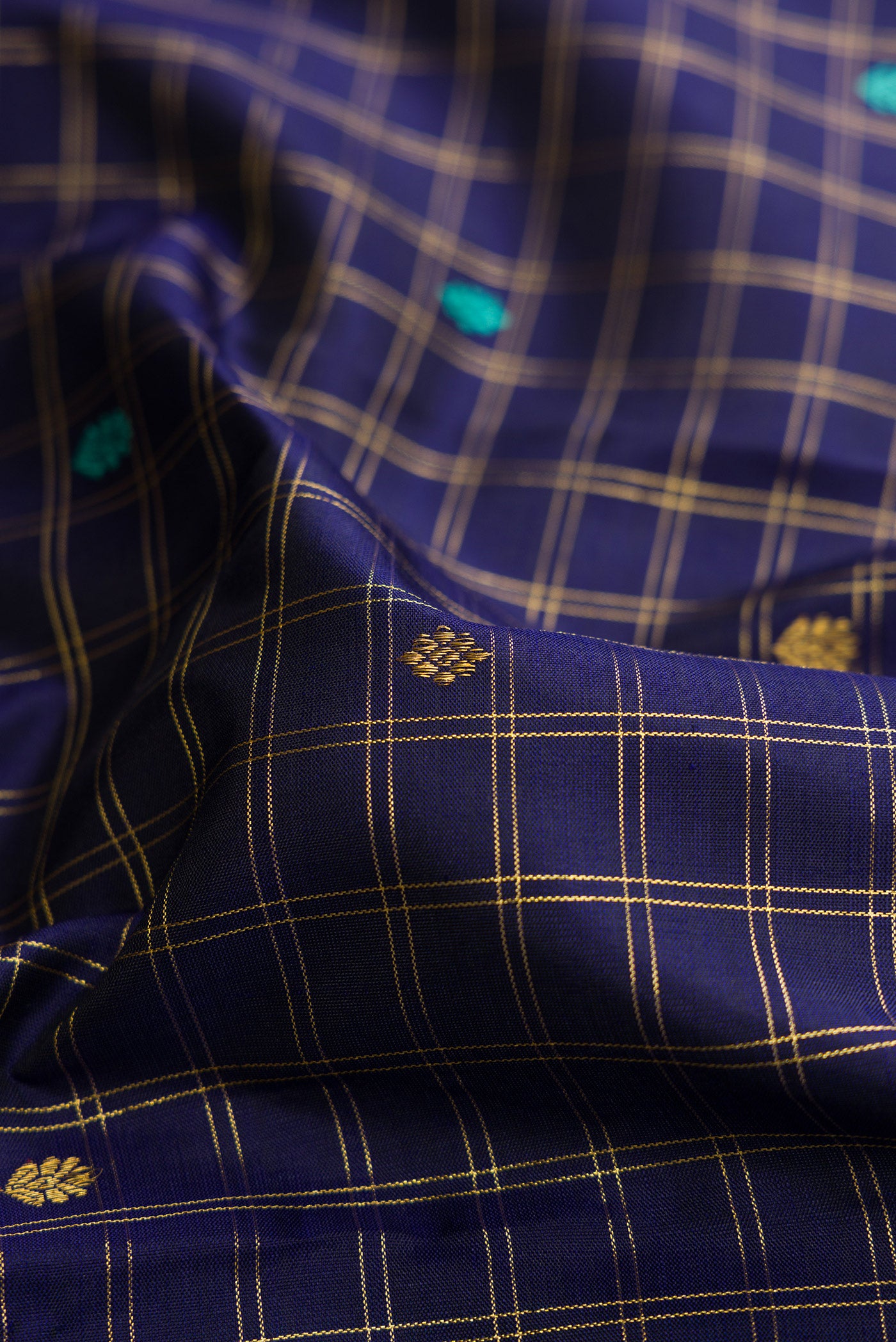 Close up of Royal Blue Dual Tone Kanjivaram Silk Saree with Zari Butta on the body and Zari Border.  displaying folds