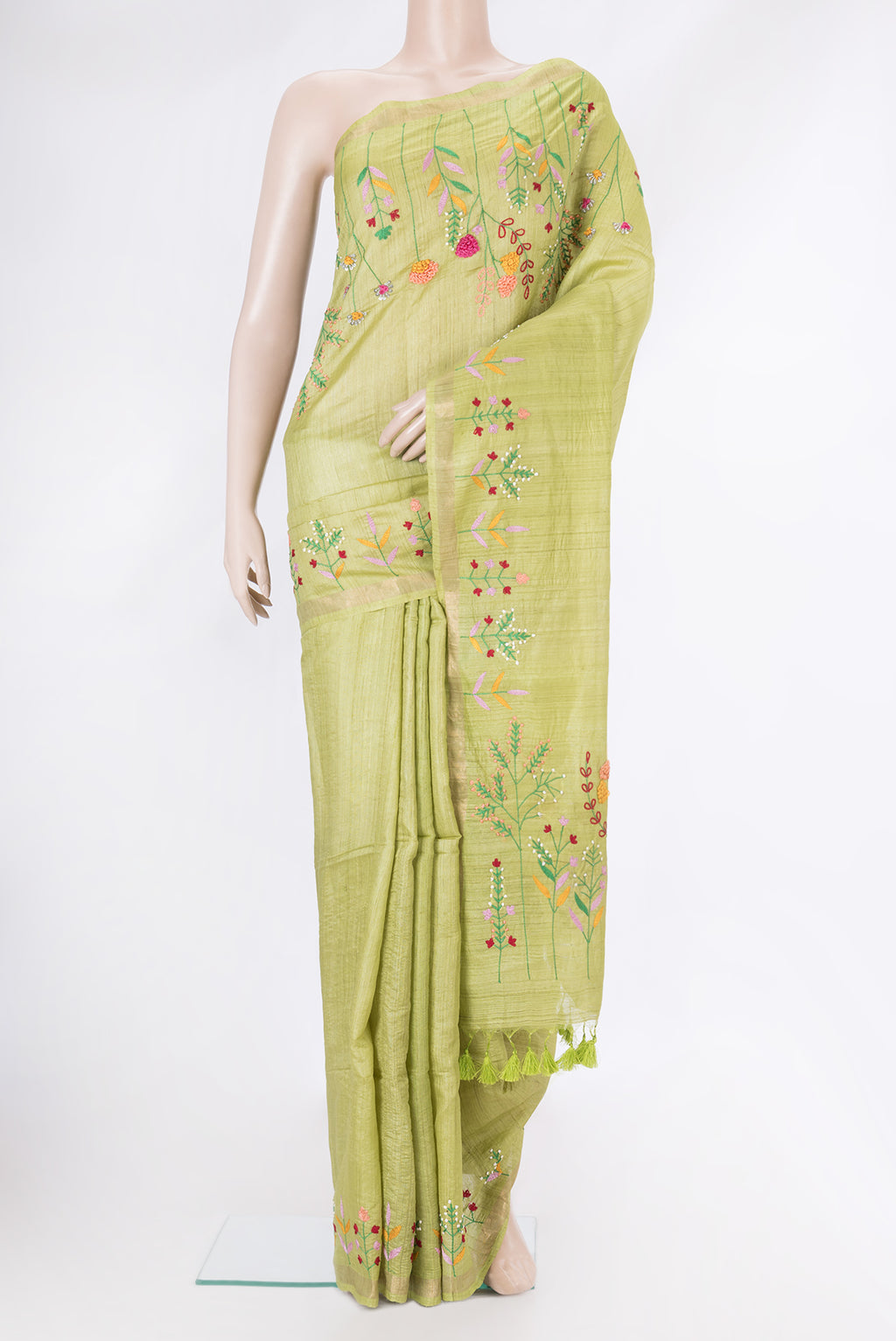 Pista Green Tussar Silk Saree with Plain Body and Embroidery Border.  displayed on a mannequin