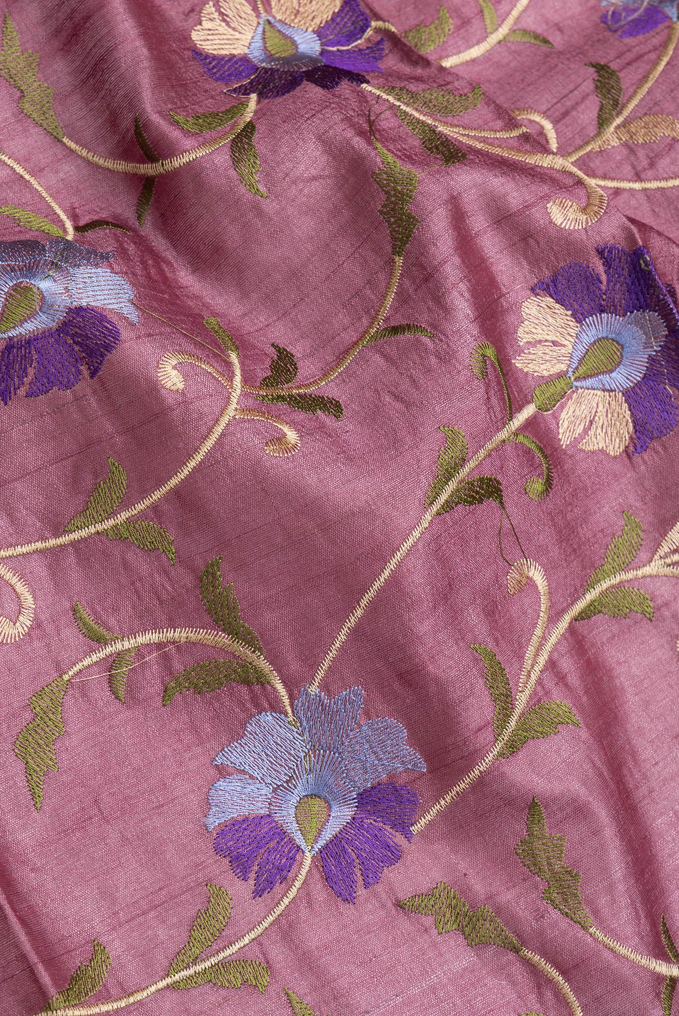Close up of Pink Dual Tone Tussar Silk Saree with Embroidery on the body and Zari Border.  displaying folds