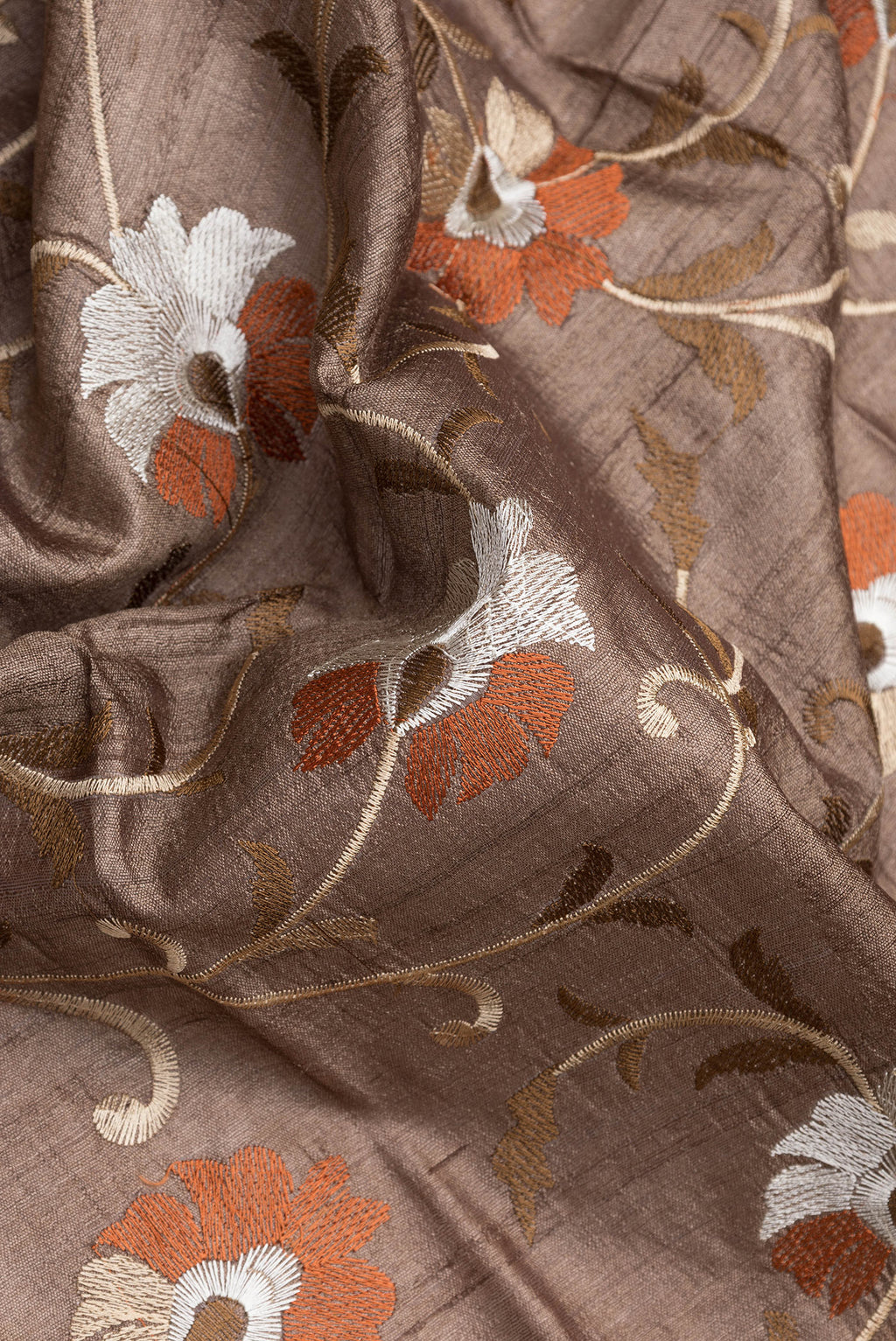Close up of Brown Tussar Silk Saree with Embroidery on the body and Embroidery Border.  displaying folds