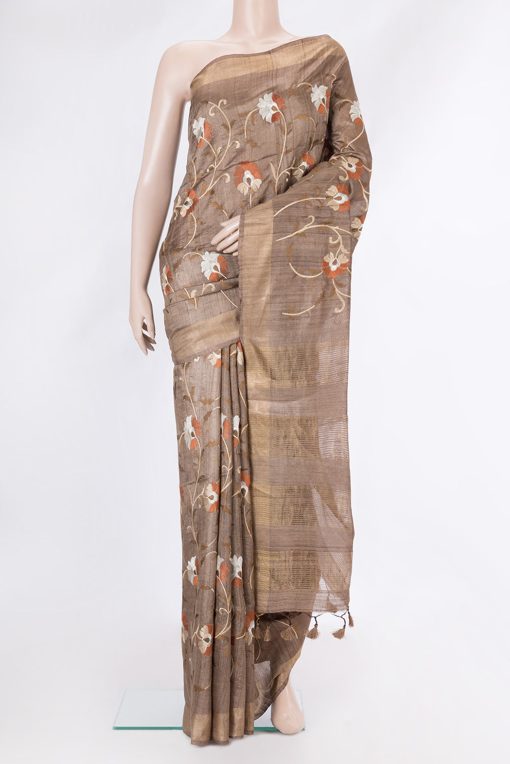 Brown Tussar Silk Saree with Embroidery on the body and Embroidery Border.  displayed on a mannequin