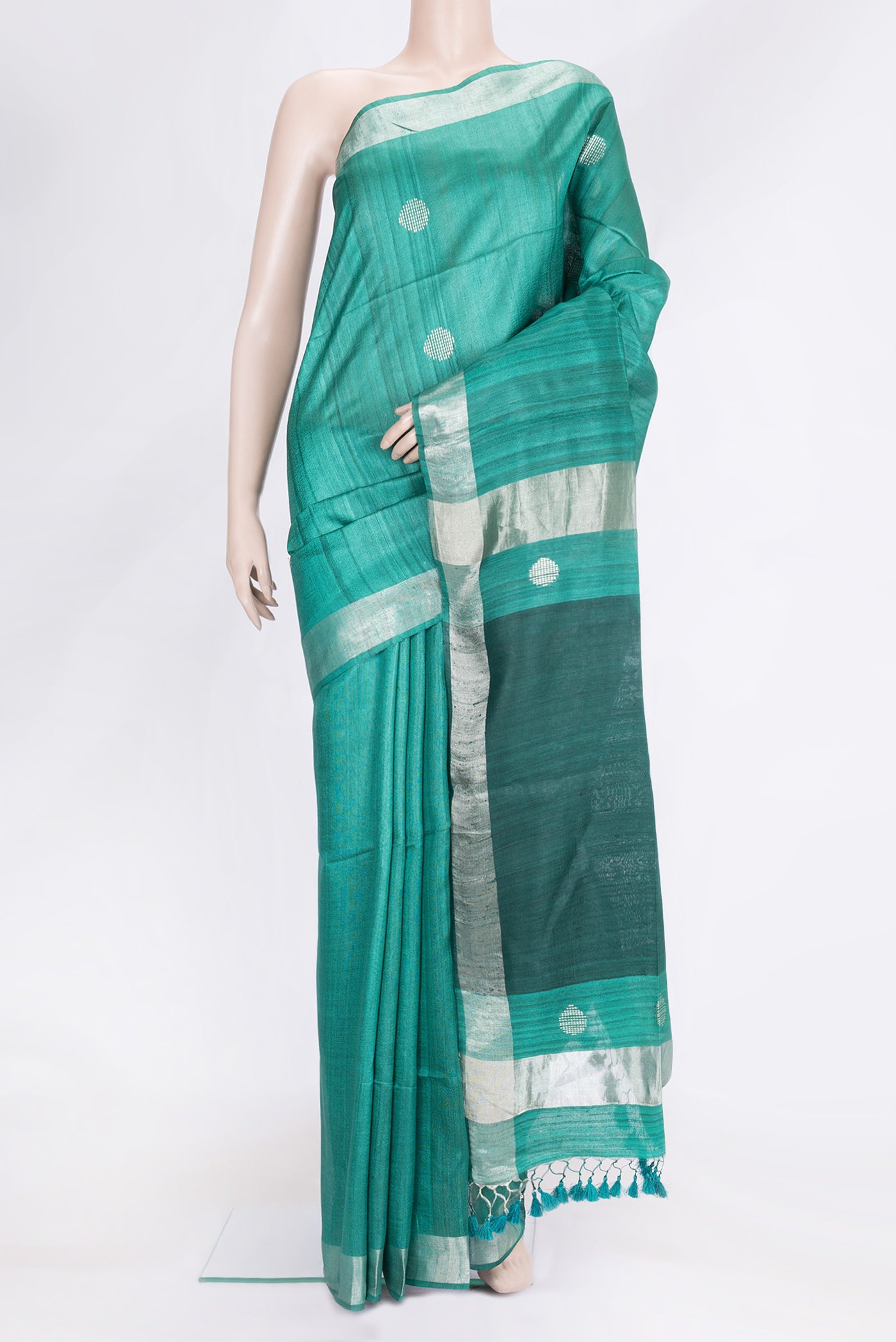 Green Dual Tone Tussar Silk Saree with Zari Butta on the body and Zari Border.  displayed on a mannequin