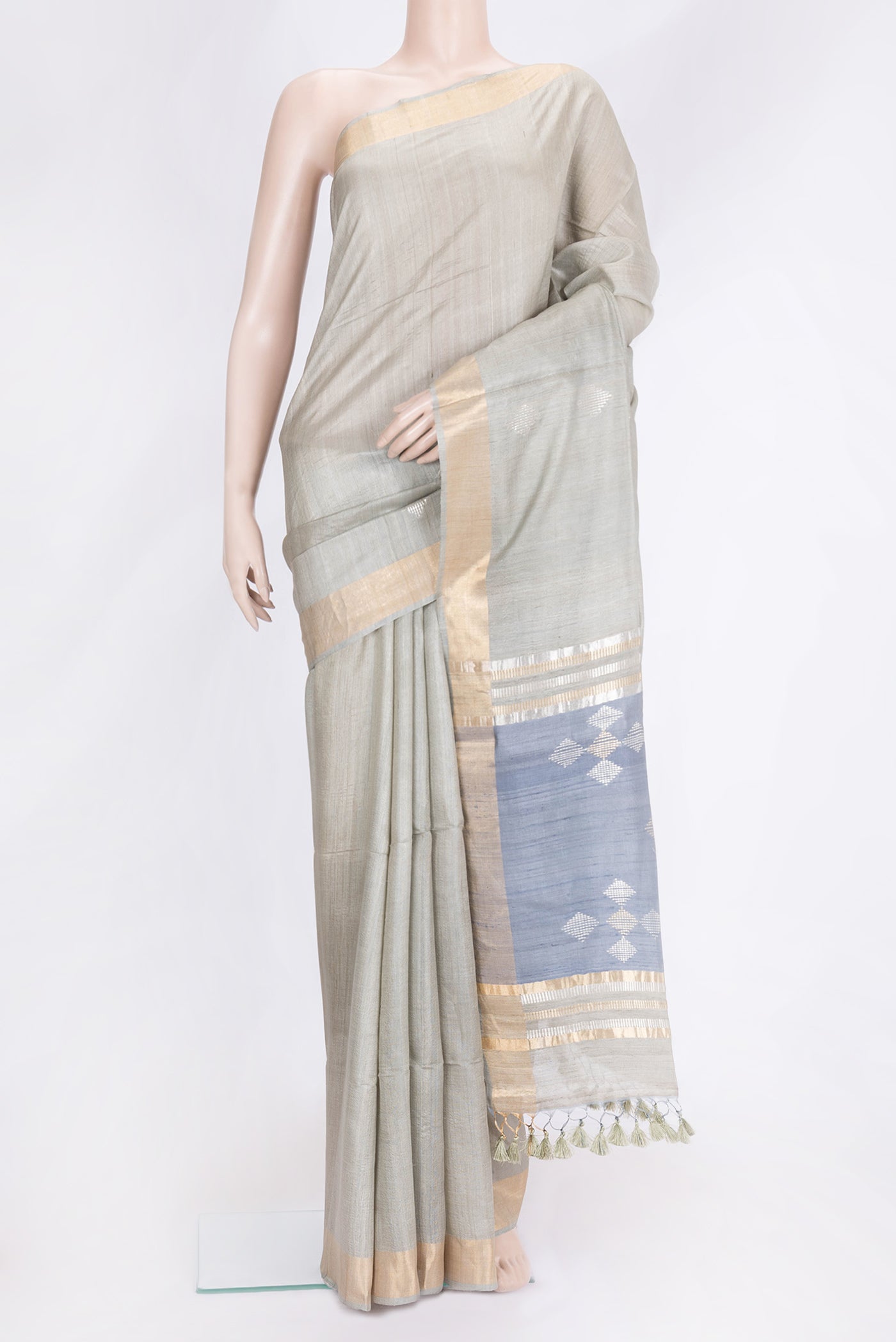 Blue Grey Dual Tone Tussar Silk Saree with Zari Butta on the body and Zari Border.  displayed on a mannequin