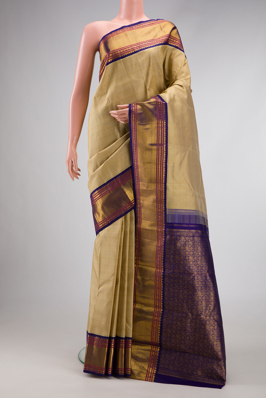 Beige Dual Tone Kanjivaram Silk Saree with Plain Body and Zari Border.  displayed on a mannequin