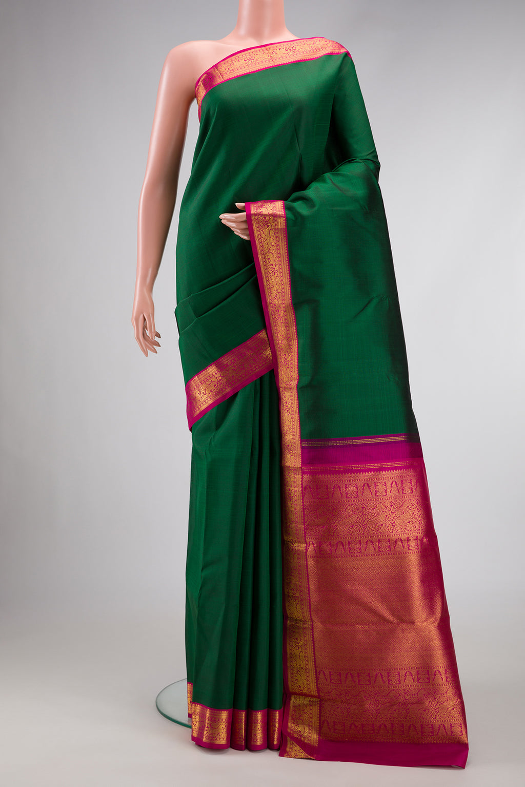 Bottle Green Dual Tone Kanjivaram Silk Saree with Plain Body and Zari Border.  displayed on a mannequin