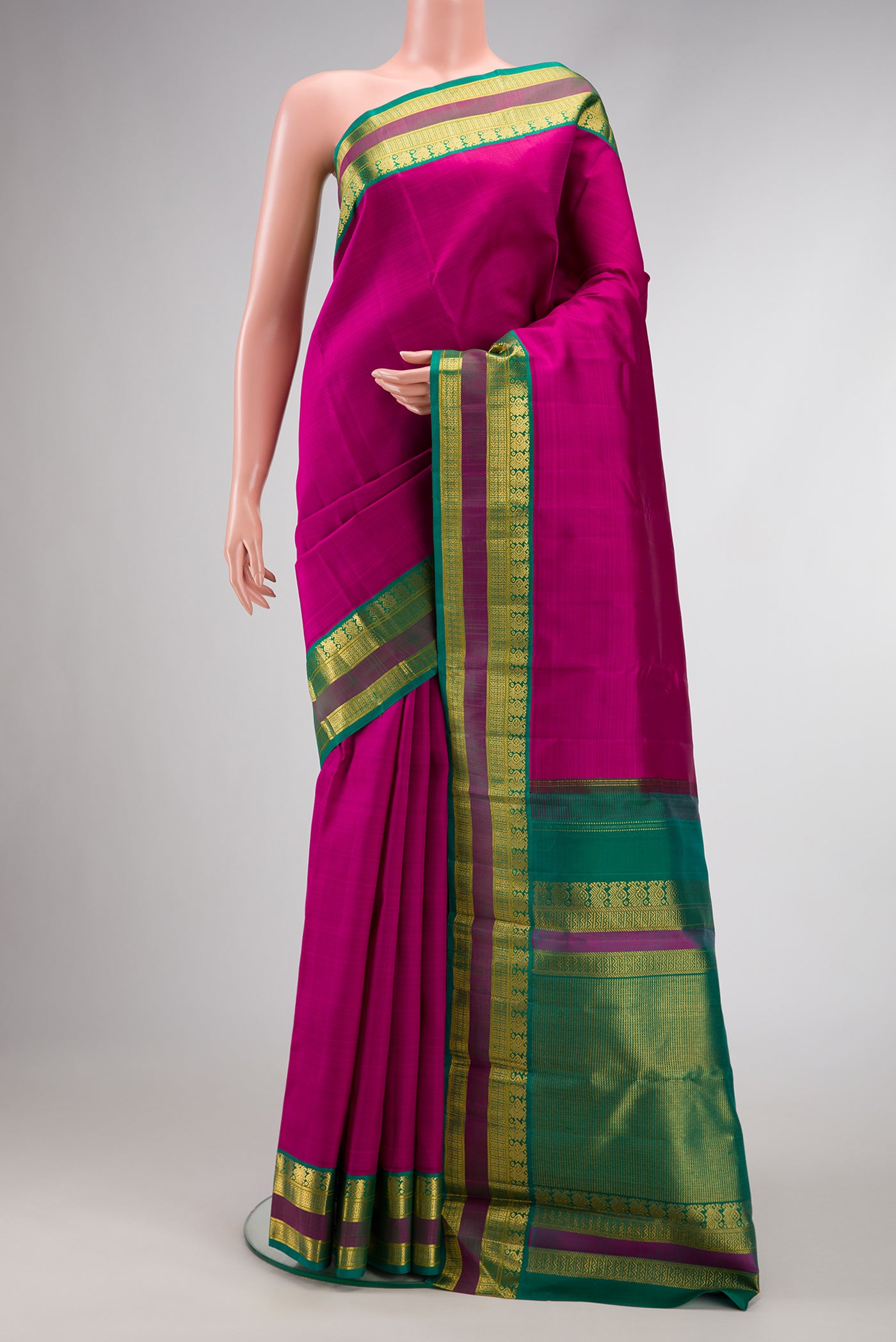 Magenta Dual Tone Kanjivaram Silk Saree with Plain Body and Zari Border.  displayed on a mannequin