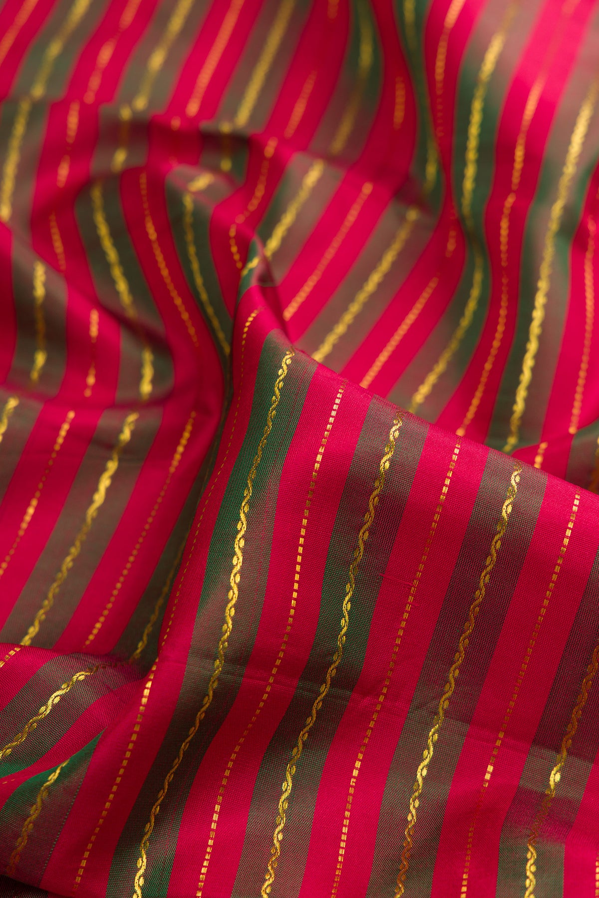 Close up of Maroon Dual Tone Kanchipuram Silk Nine Yards Saree with Stripes on the body and Zari Border.  displaying folds
