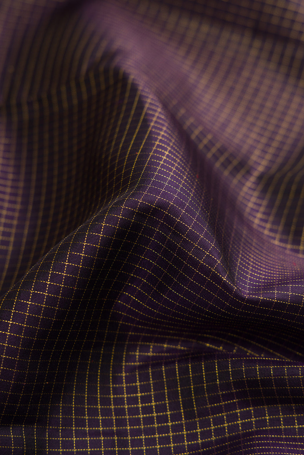 Close up of Pure Silk Pure Zari Burgundy Dual Tone Kanjivaram Saree with Checked design on the body and Zari Border.  displaying folds