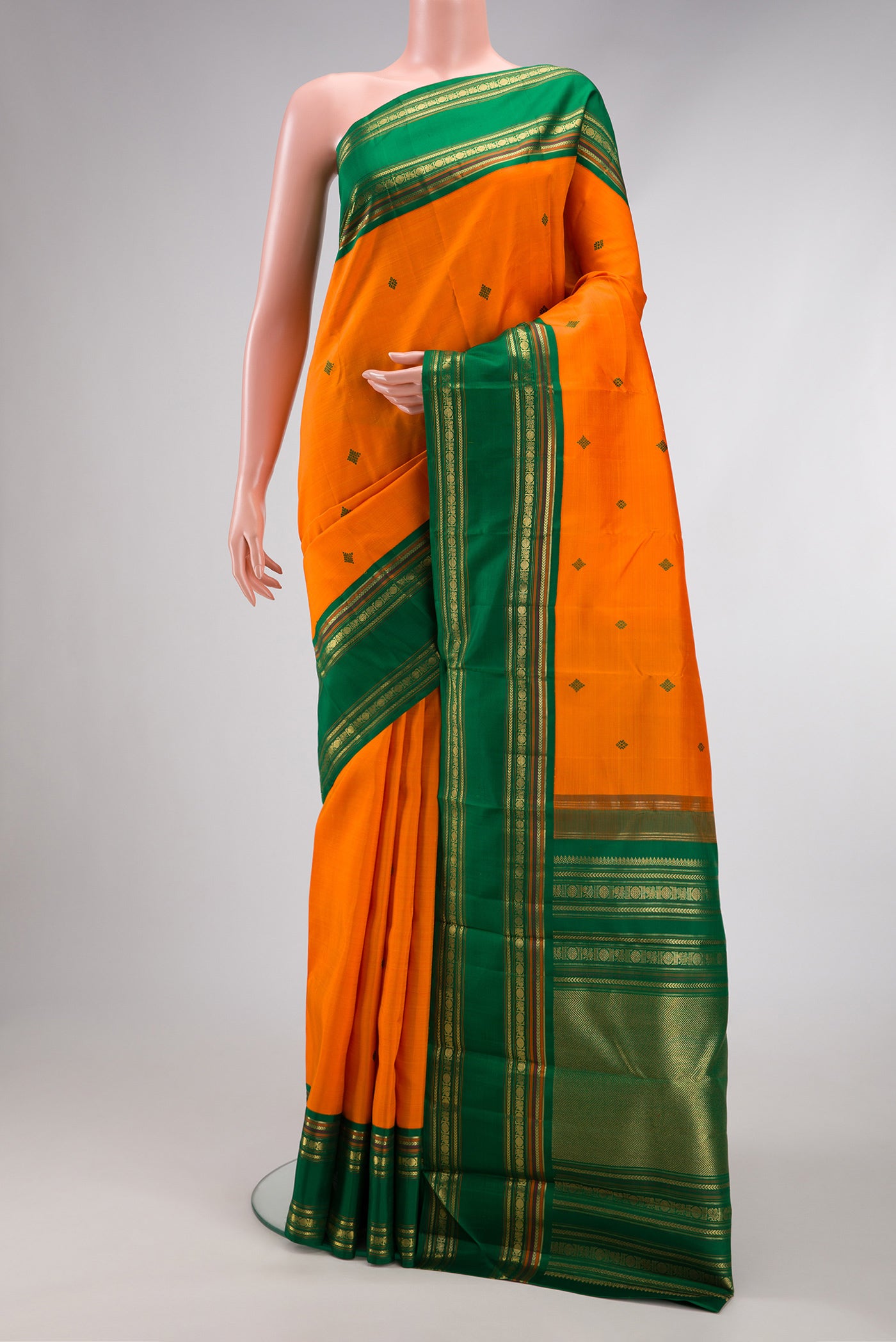 Pure Silk Pure Zari Orange Dual Tone Kanchipuram Saree with Thread Butta on the body and Zari Border.  displayed on a mannequin