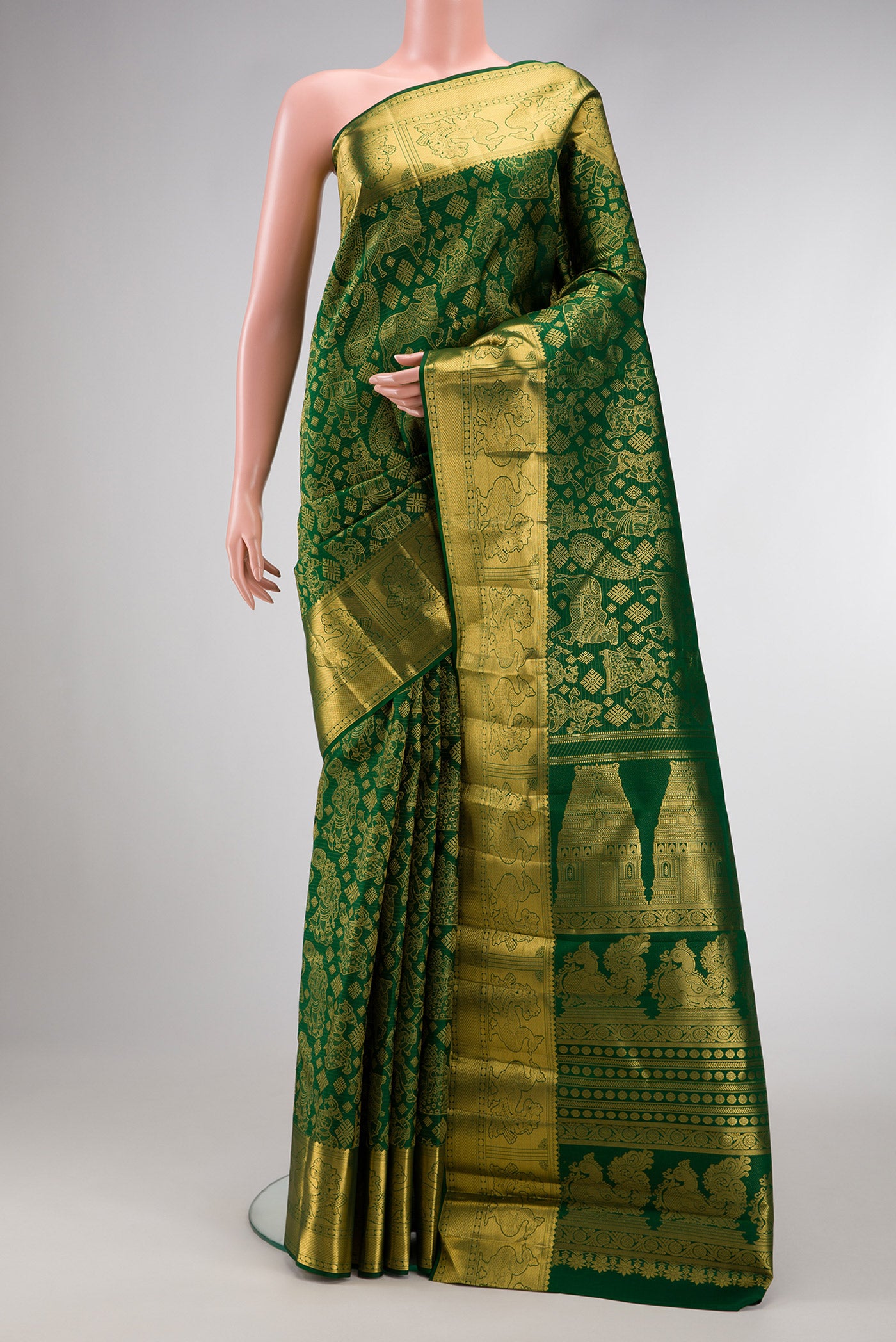 Green Dual Tone Kanchipuram Silk Saree with Zari Butta on the body and Zari Border.  displayed on a mannequin