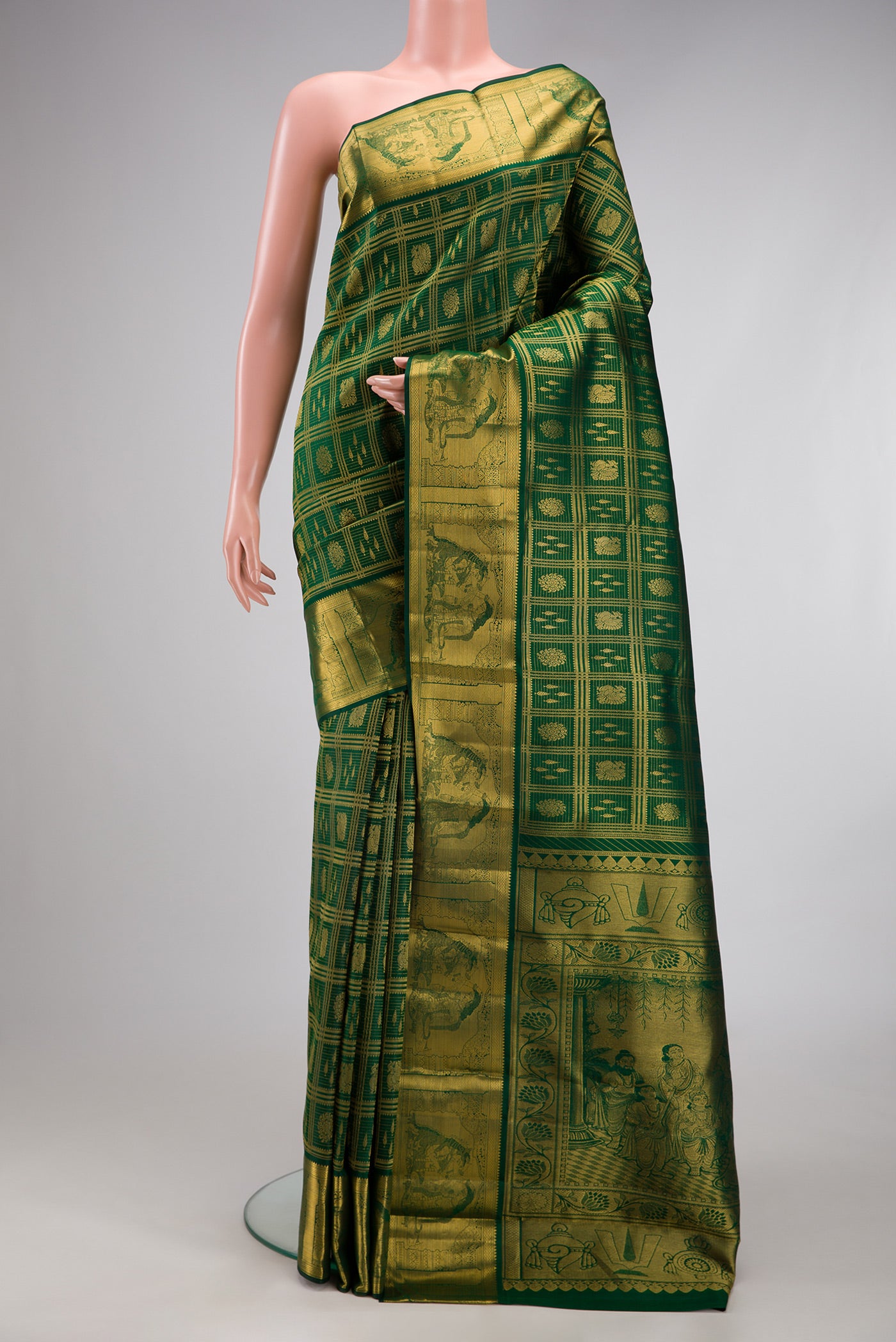Bottle Green Kanchipuram Silk Saree with Zari Brocade on the body and Zari Border.  displayed on a mannequin