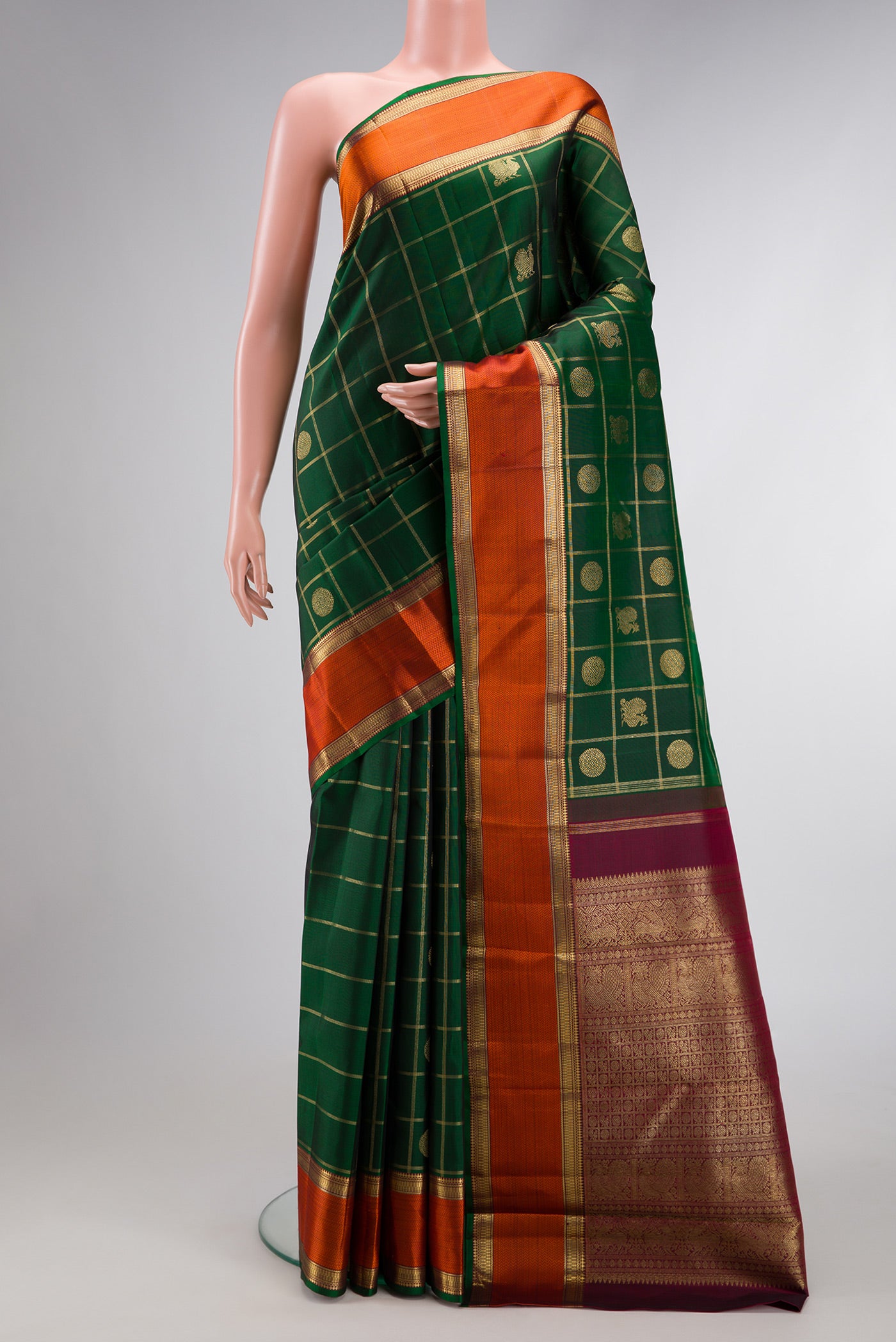 Pure Silk Pure Zari Bottle Green Dual Tone Kanjivaram Saree with Checked design on the body and Zari And Thread Border.  displayed on a mannequin