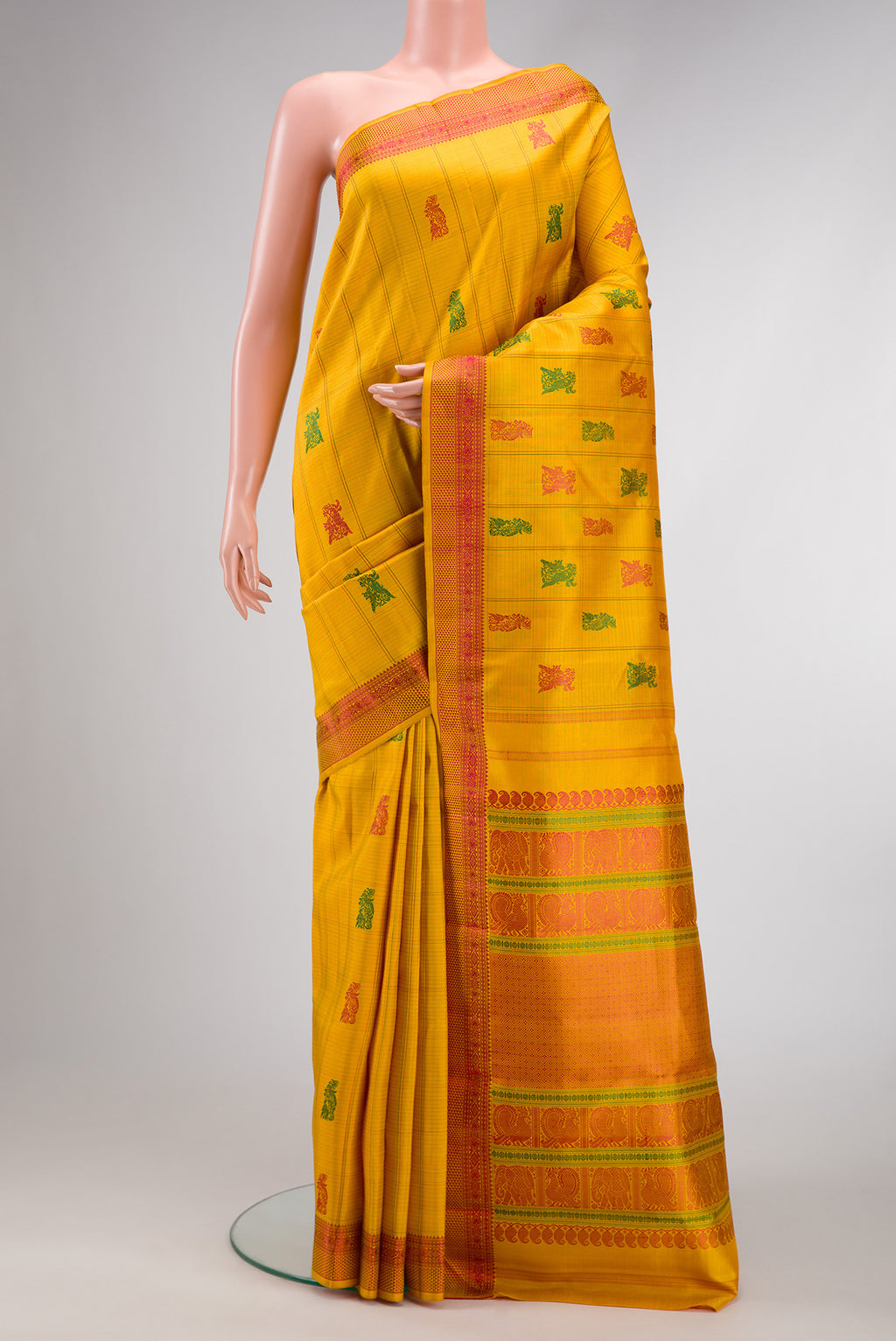 Mustard Dual Tone Kanchipuram Silk Saree with Stripes on the body and Fancy Border.  displayed on a mannequin
