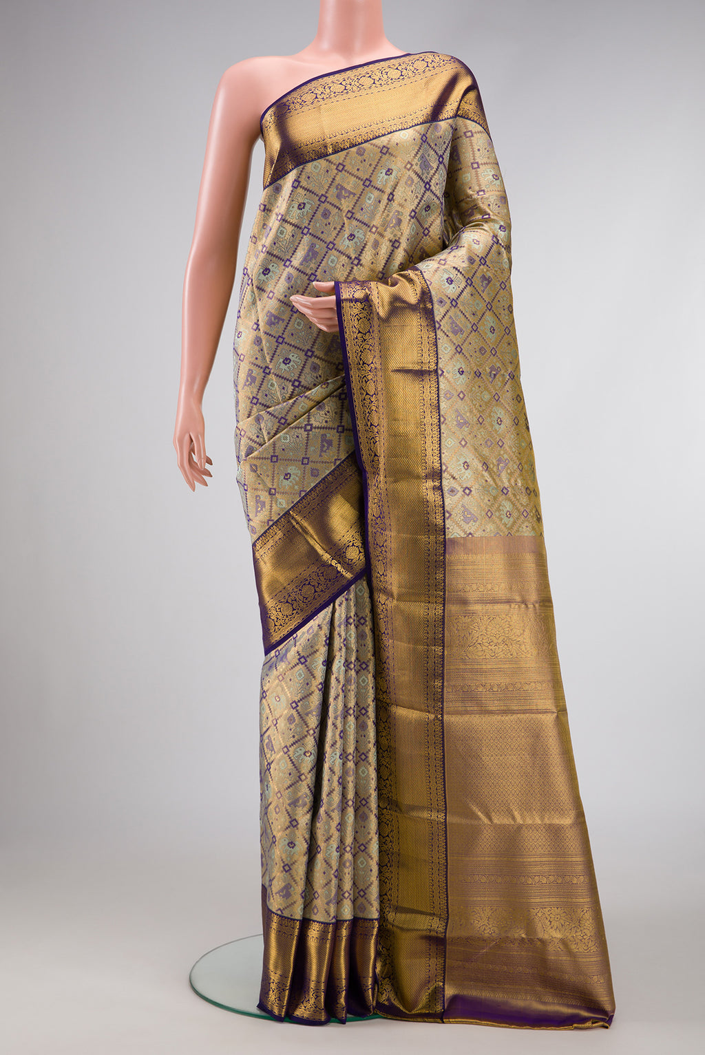 Gold Dual Tone Kanchipuram Tissue Silk Saree with Zari Brocade on the body and Zari Border.  displayed on a mannequin
