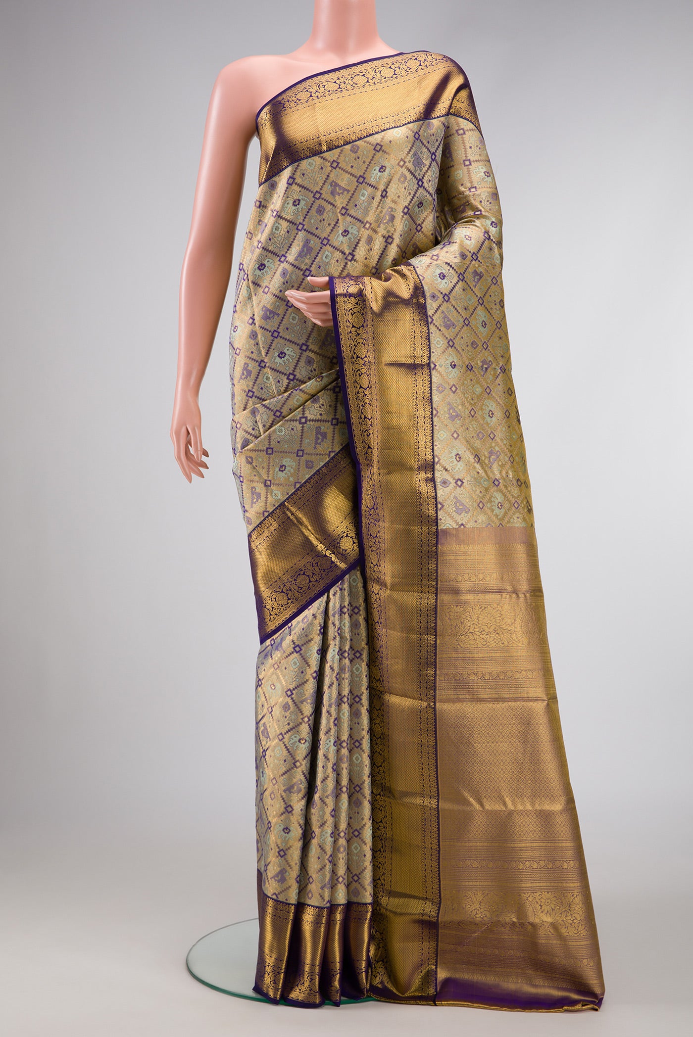 Gold Dual Tone Kanchipuram Tissue Silk Saree with Zari Brocade on the body and Zari Border.  displayed on a mannequin