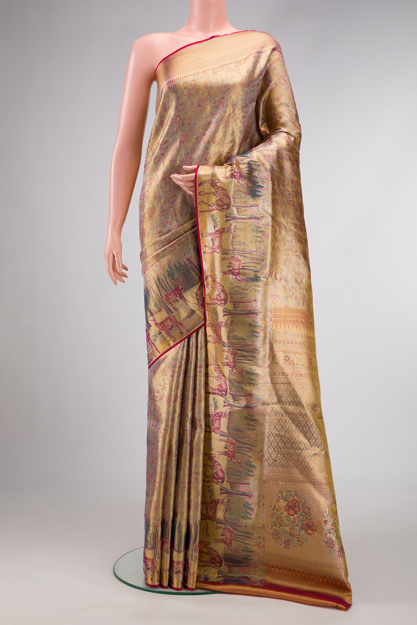 Gold Dual Tone Kanjivaram Tissue Silk Saree with Zari Brocade on the body and Fancy Border.  displayed on a mannequin