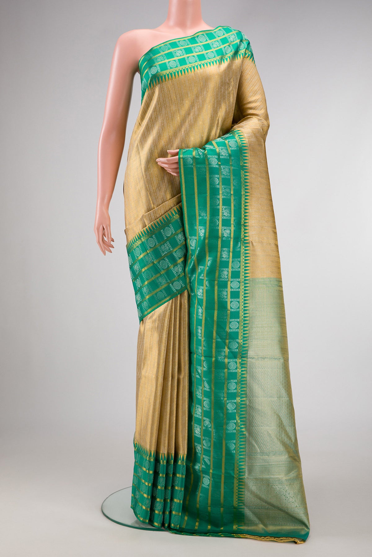 Gold Dual Tone Kanjivaram Tissue Silk Saree with Zari Brocade on the body and Fancy Border.  displayed on a mannequin