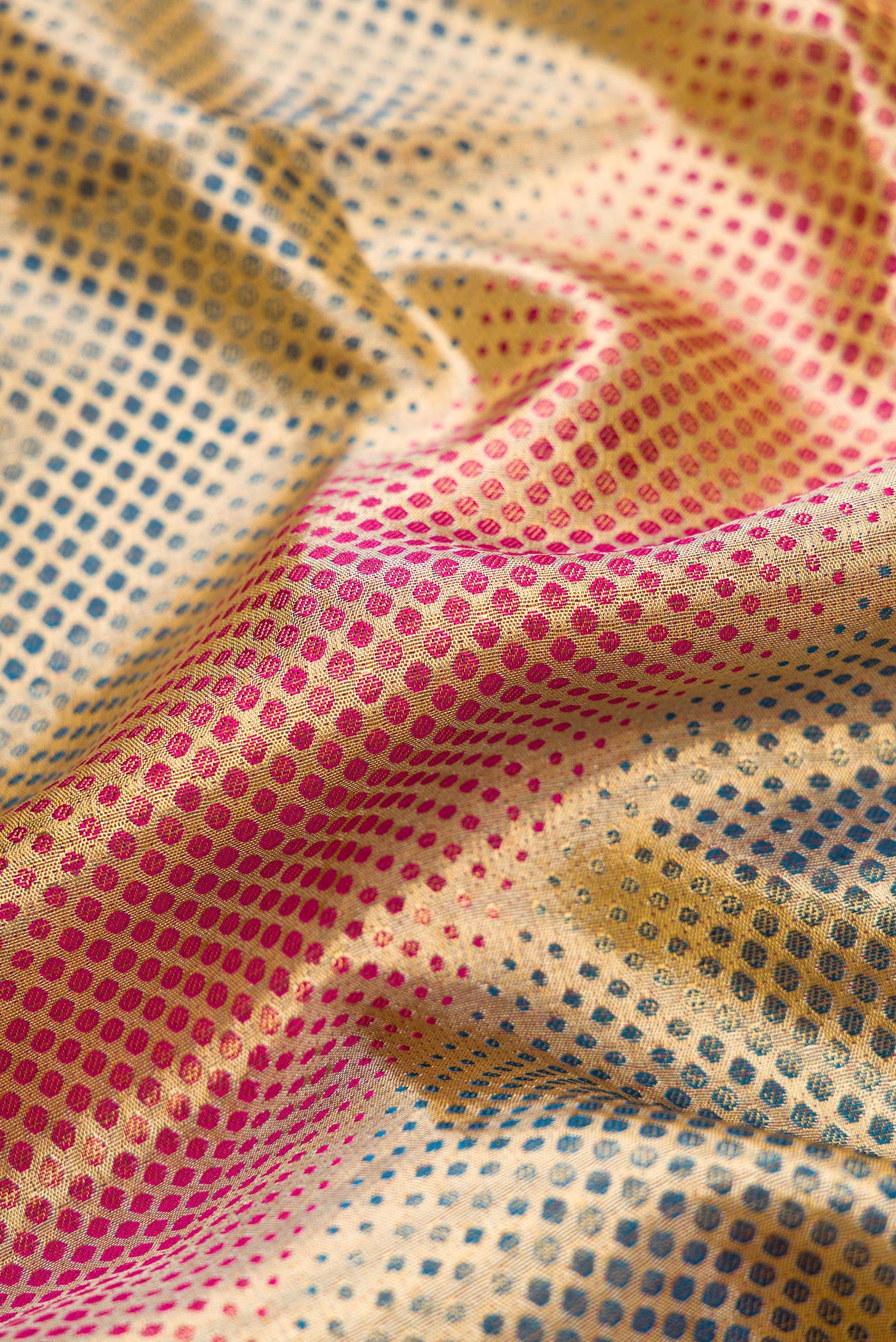 Close up of Gold Dual Tone Kanjivaram Tissue Silk Saree with Zari Brocade on the body and Fancy Border.  displaying folds