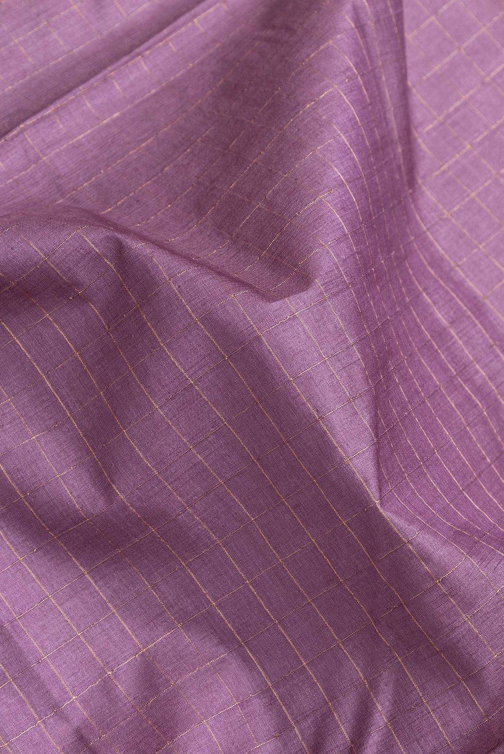 Close up of Purple Dual Tone Tussar Silk Saree with Checked design on the body and Printed Border.  displaying folds