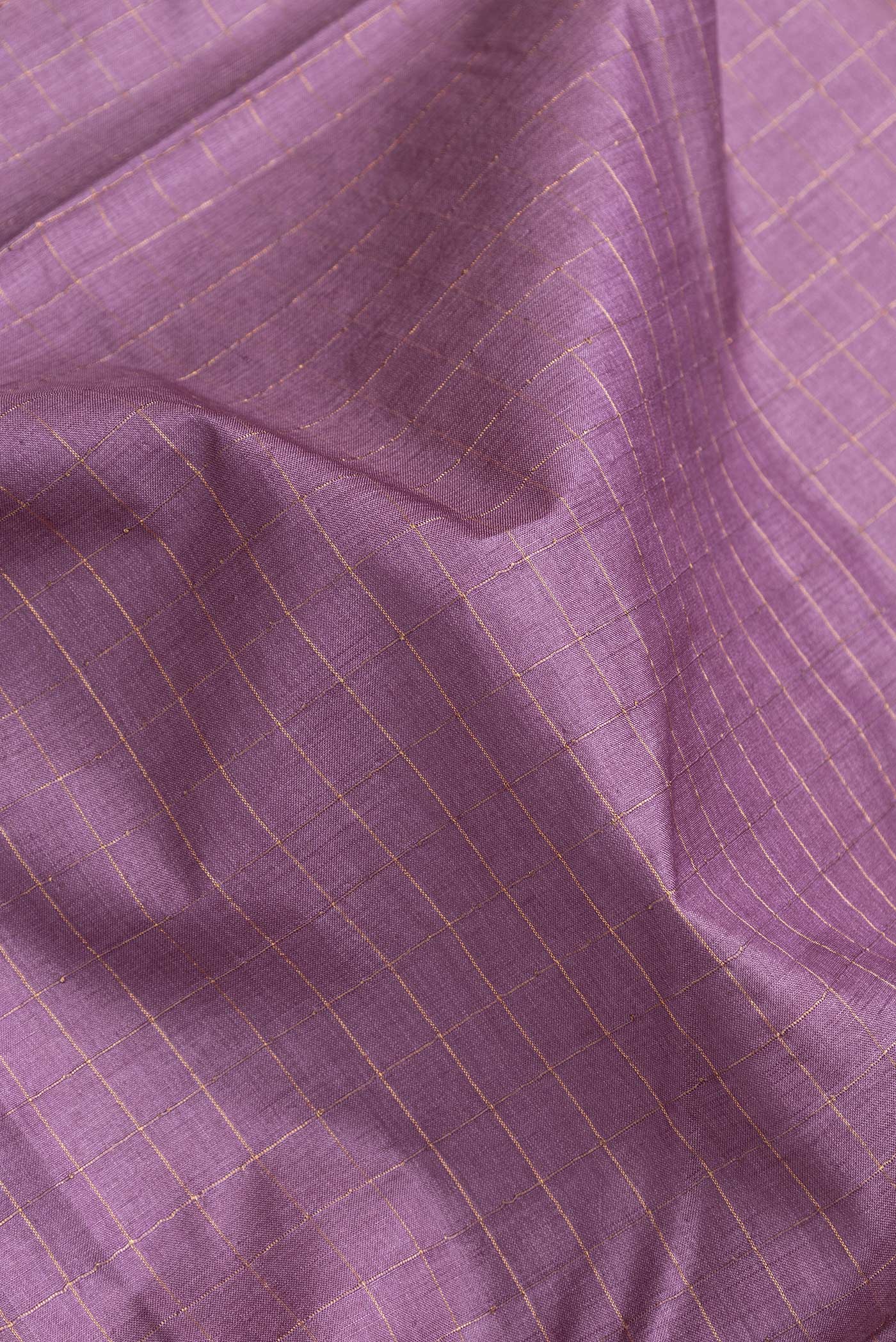 Close up of Purple Dual Tone Tussar Silk Saree with Checked design on the body and Printed Border.  displaying folds