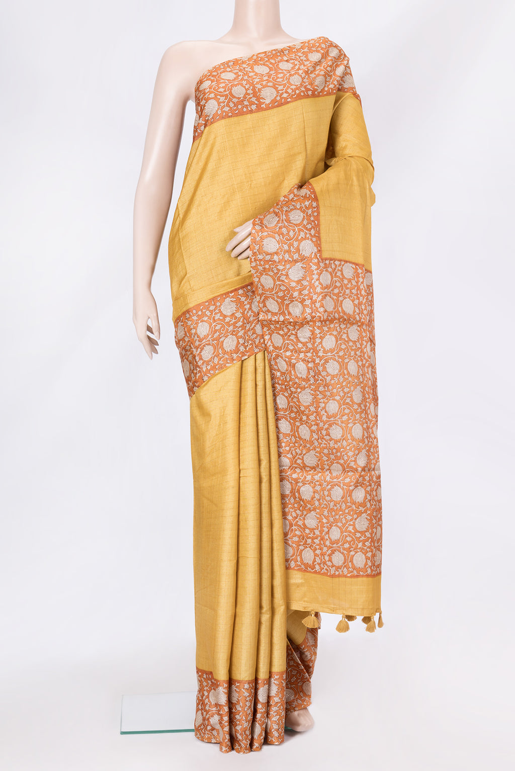 Mustard Dual Tone Tussar Silk Saree with Checked design on the body and Printed Border.  displayed on a mannequin