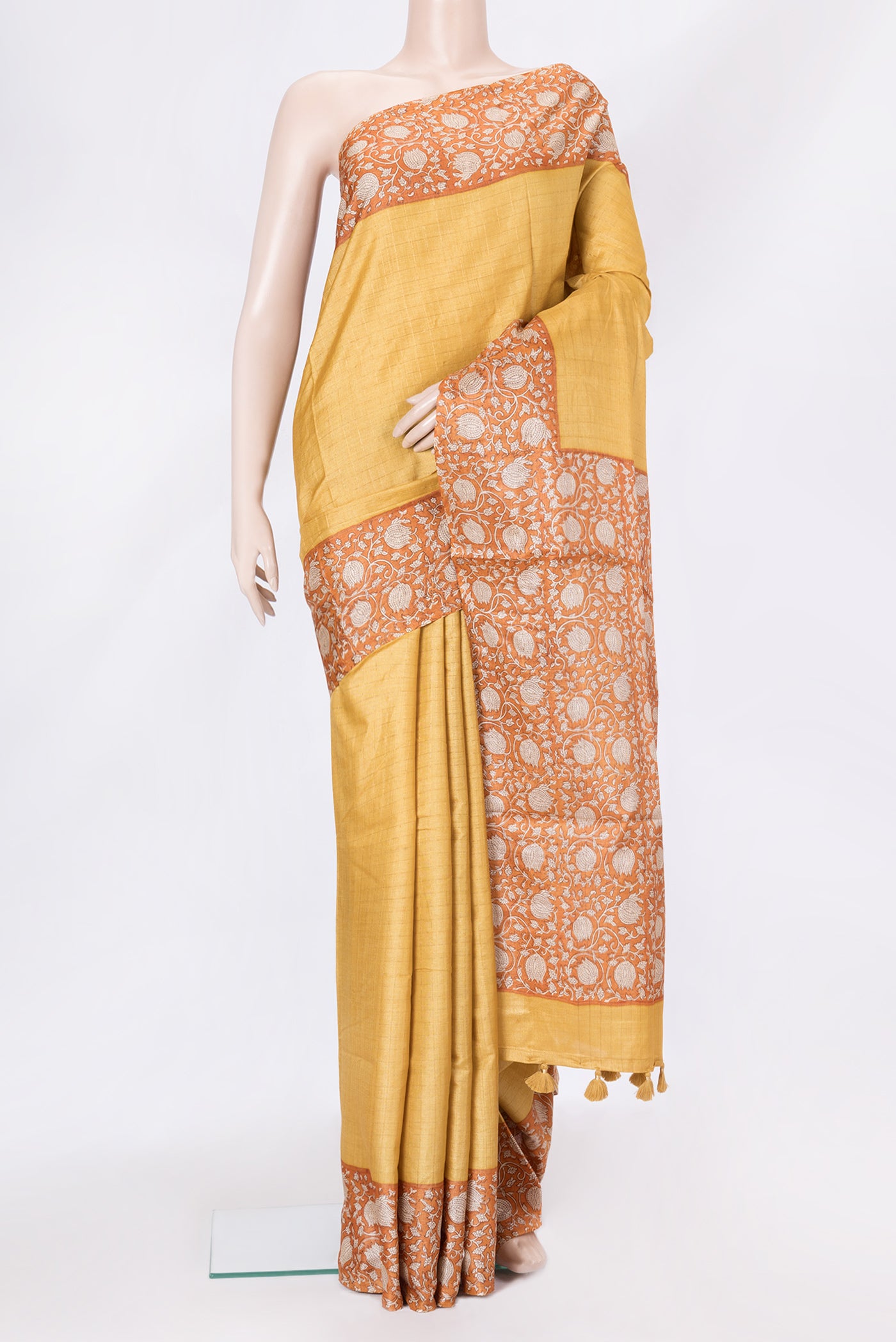 Mustard Dual Tone Tussar Silk Saree with Checked design on the body and Printed Border.  displayed on a mannequin