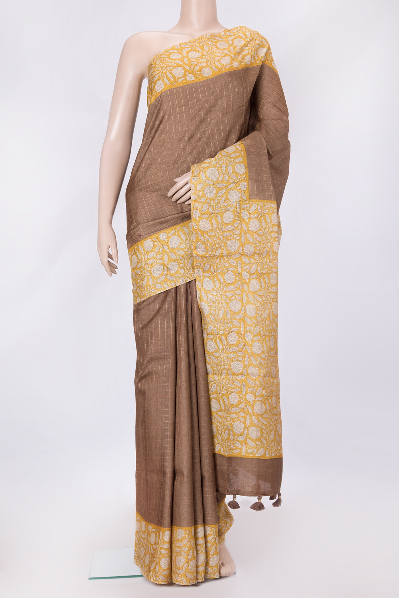 Brown Dual Tone Tussar Silk Saree with Checked design on the body and Printed Border.  displayed on a mannequin