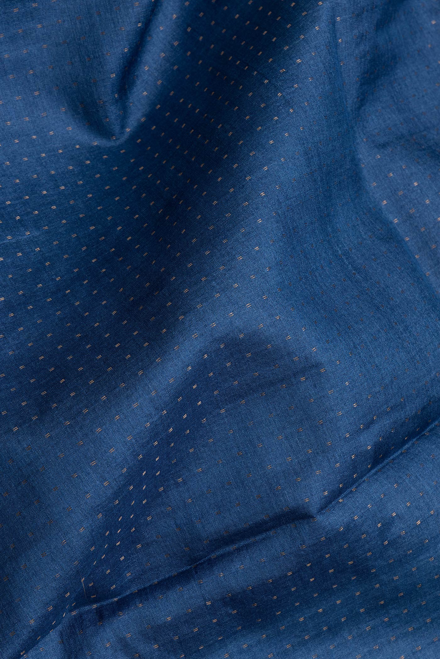 Close up of Blue Dual Tone Tussar Silk Saree with Zari Butta on the body and Printed Border.  displaying folds