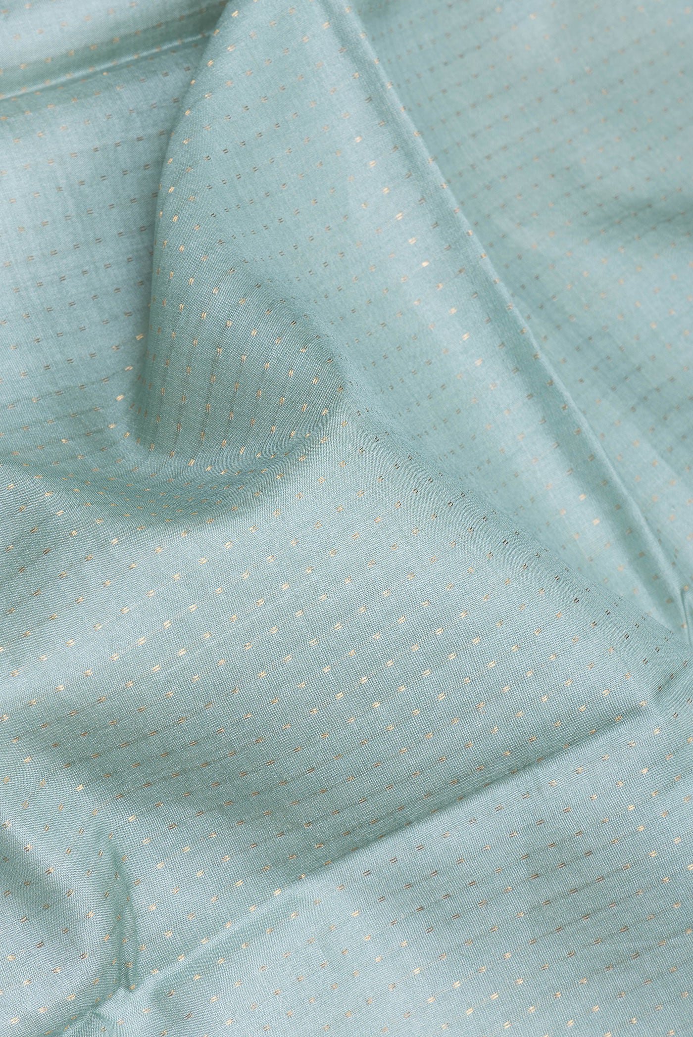 Close up of Light Blue Tussar Silk Saree with Stripes on the body and Printed Border.  displaying folds