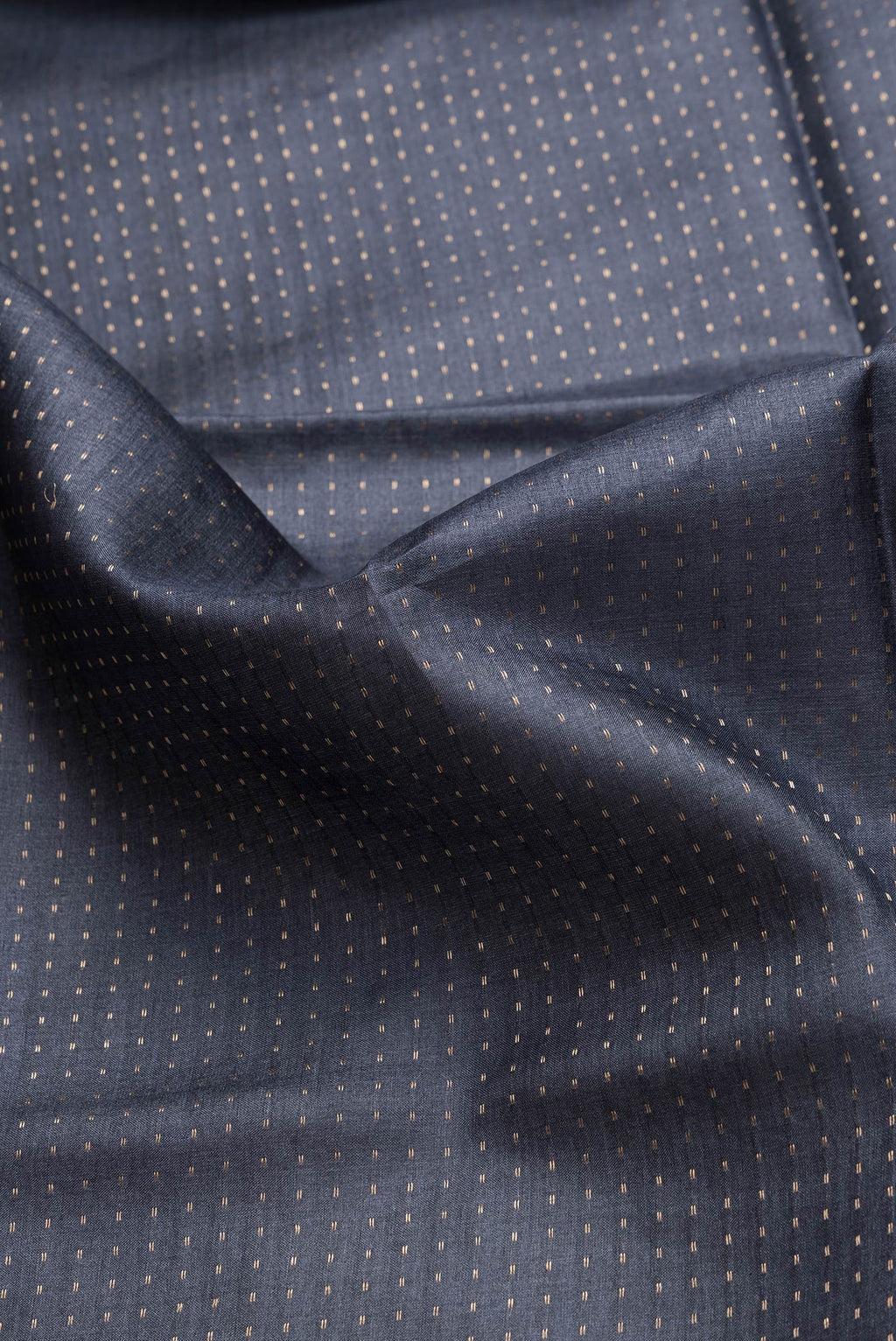 Close up of Navy Blue Dual Tone Tussar Silk Saree with Stripes on the body and Printed Border.  displaying folds