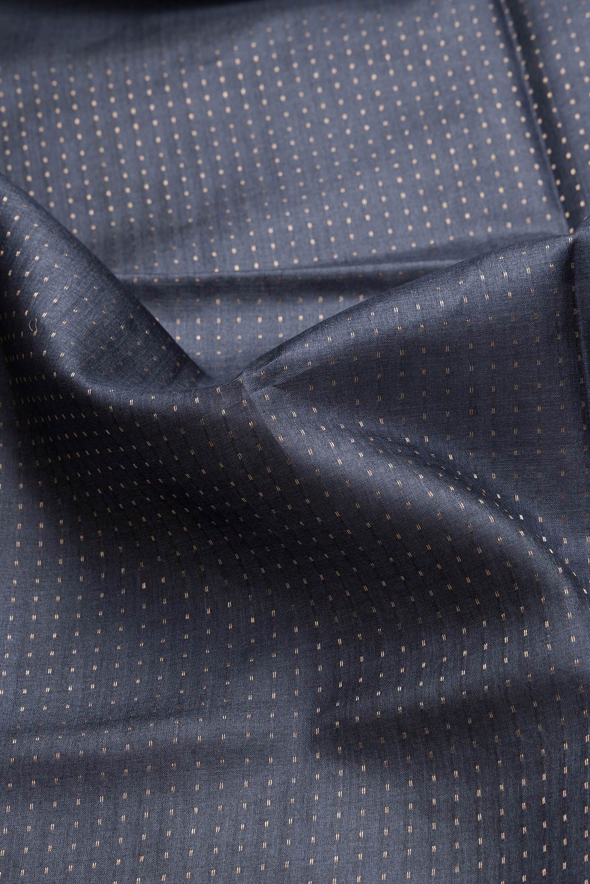Close up of Navy Blue Dual Tone Tussar Silk Saree with Stripes on the body and Printed Border.  displaying folds