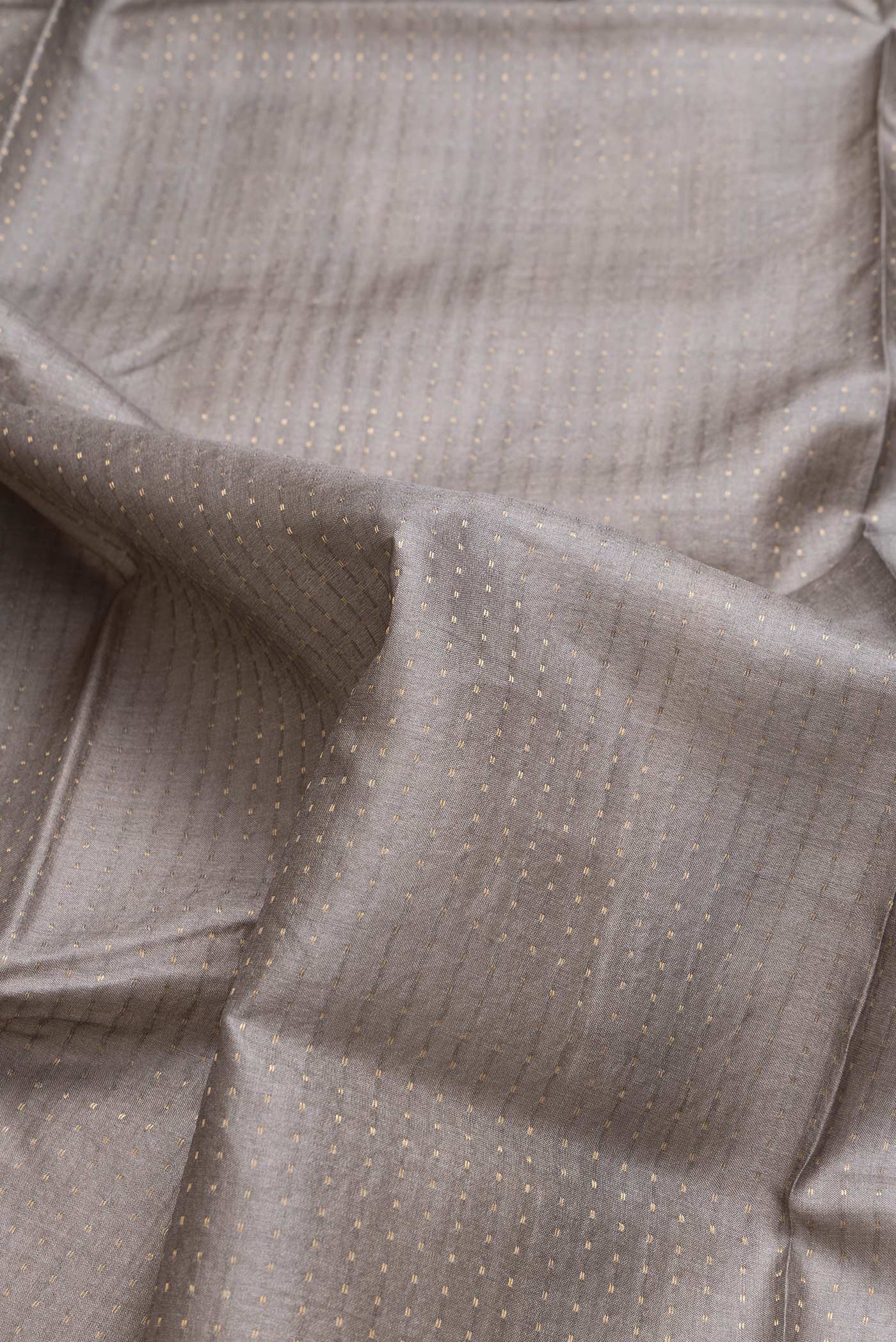 Close up of Grey Dual Tone Tussar Silk Saree with Stripes on the body and Printed Border.  displaying folds