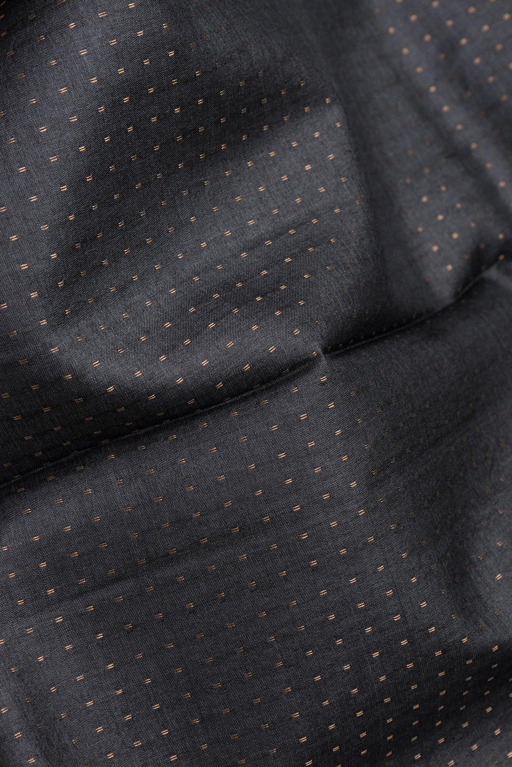 Close up of Black Dual Tone Tussar Silk Saree with Stripes on the body and Printed Border.  displaying folds