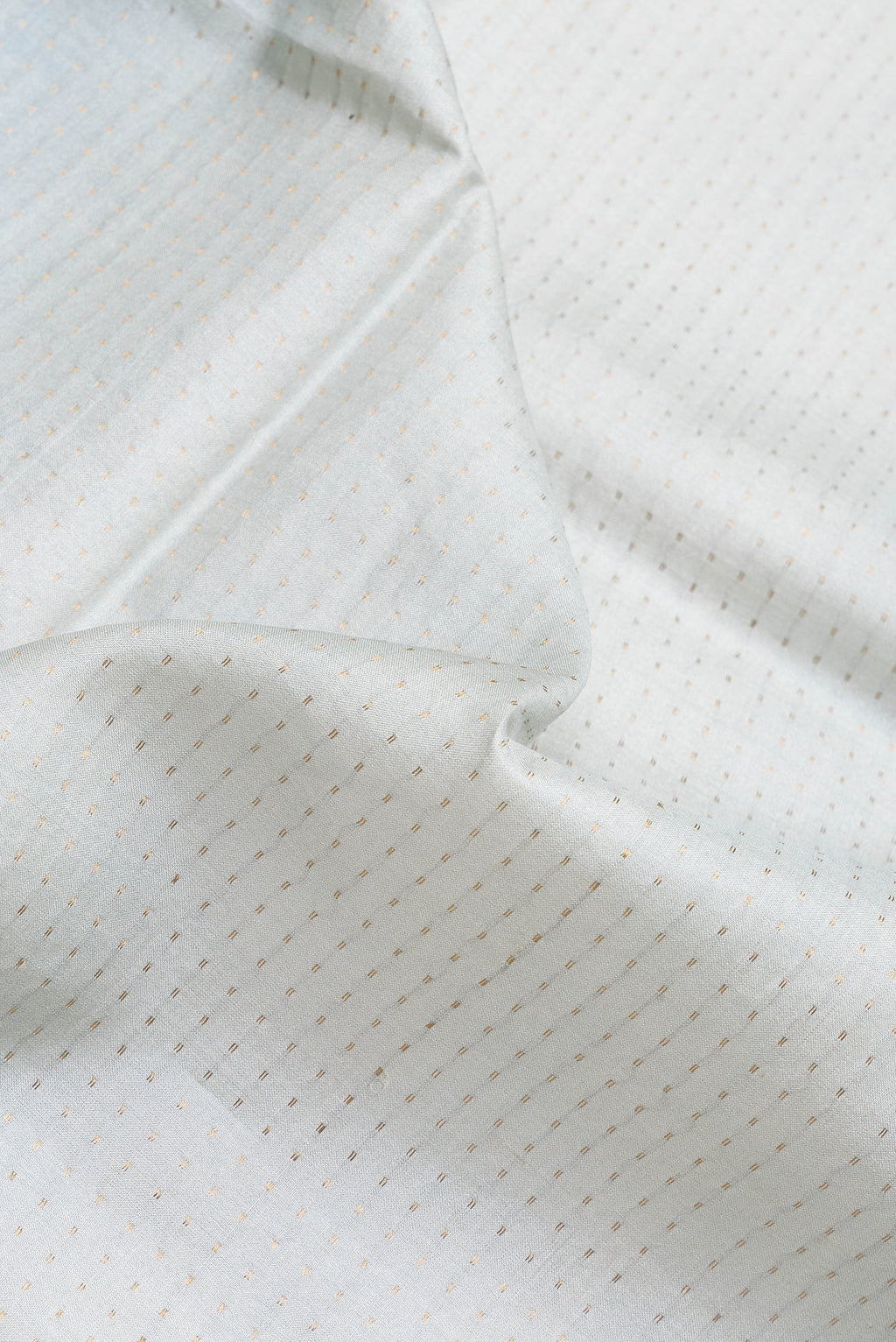 Close up of Grey Dual Tone Tussar Silk Saree with Stripes on the body and Printed Border.  displaying folds
