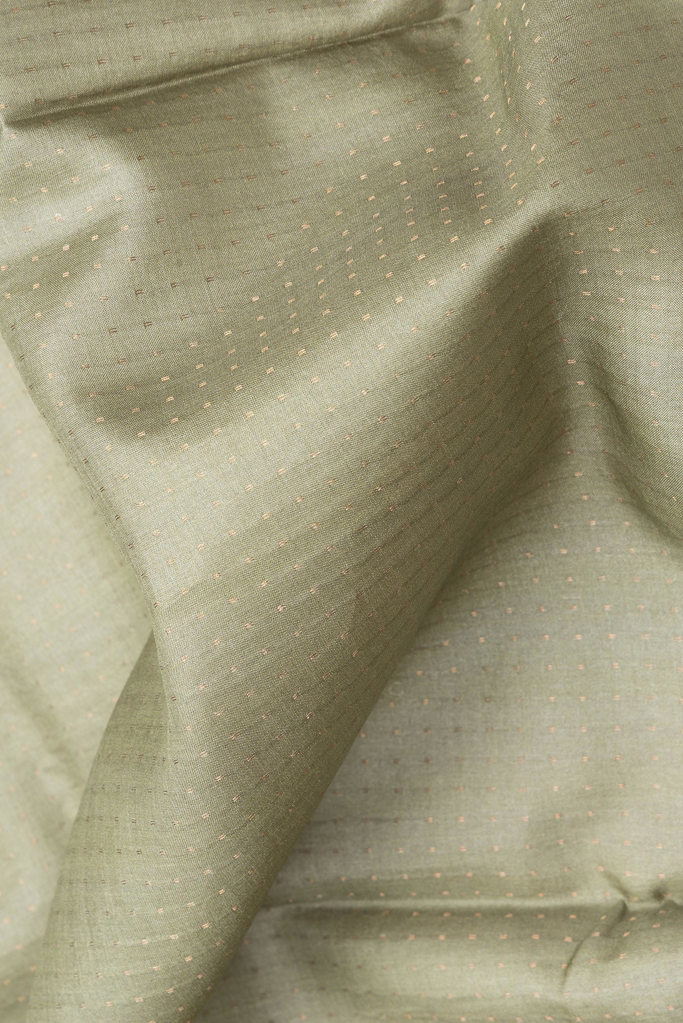 Close up of Sage Green Dual Tone Tussar Silk Saree with Stripes on the body and Zari Border.  displaying folds